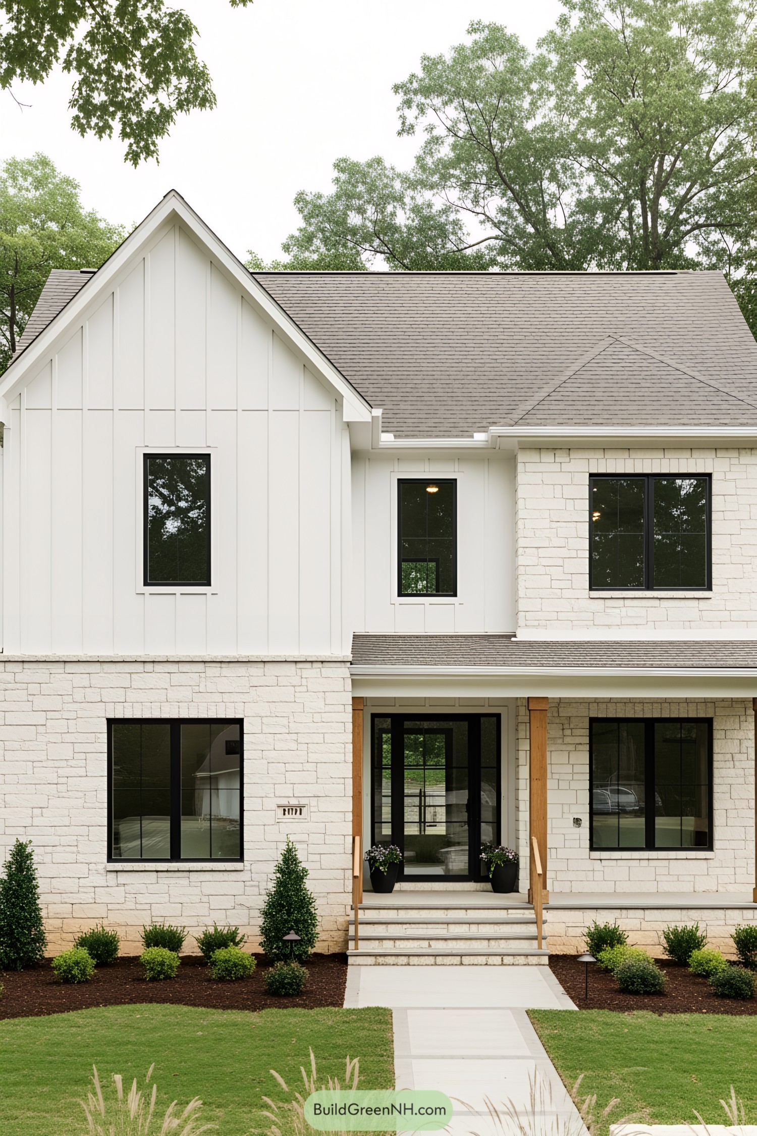 Modern white farmhouse with black windows and porch