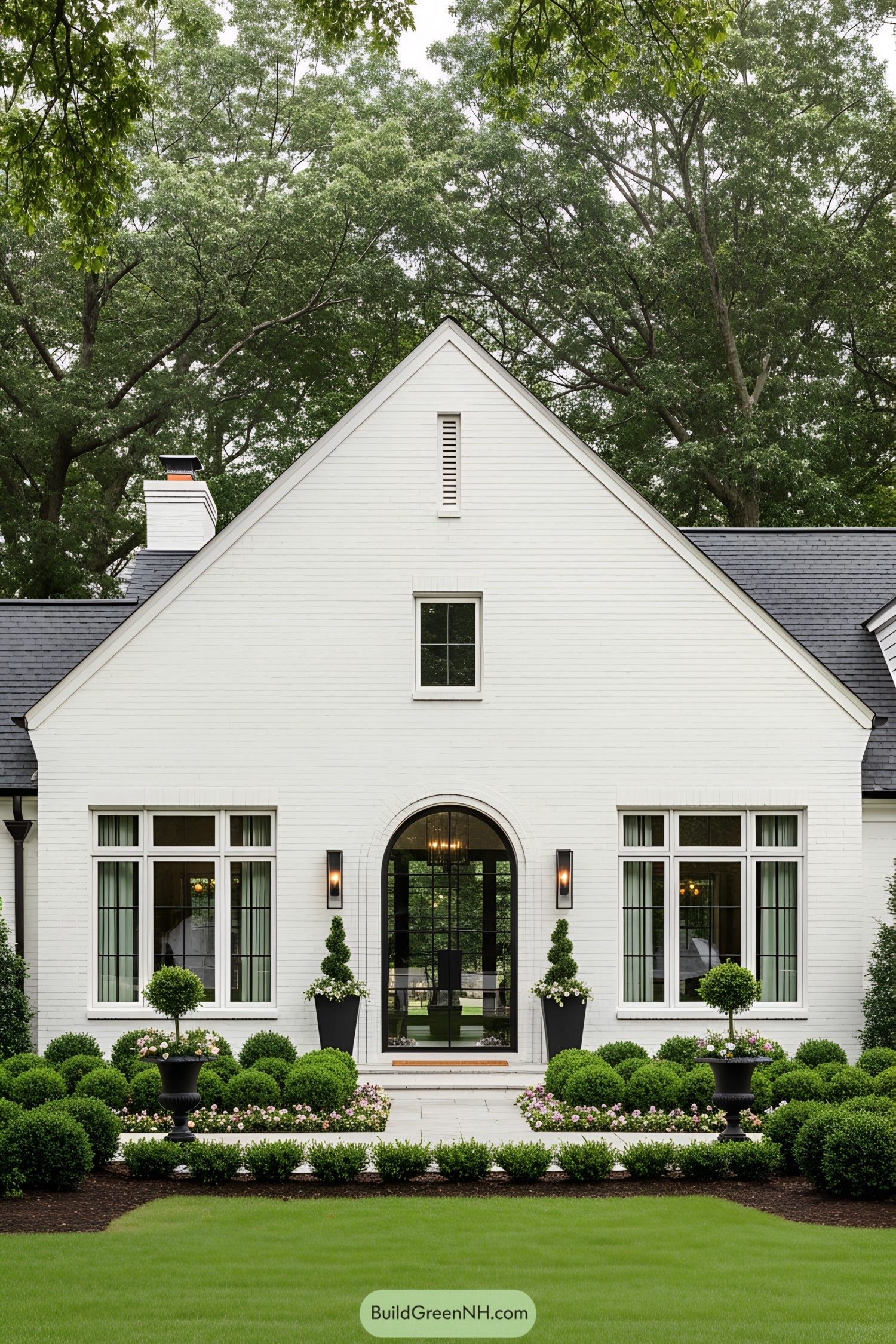 White ranch house with manicured garden in front