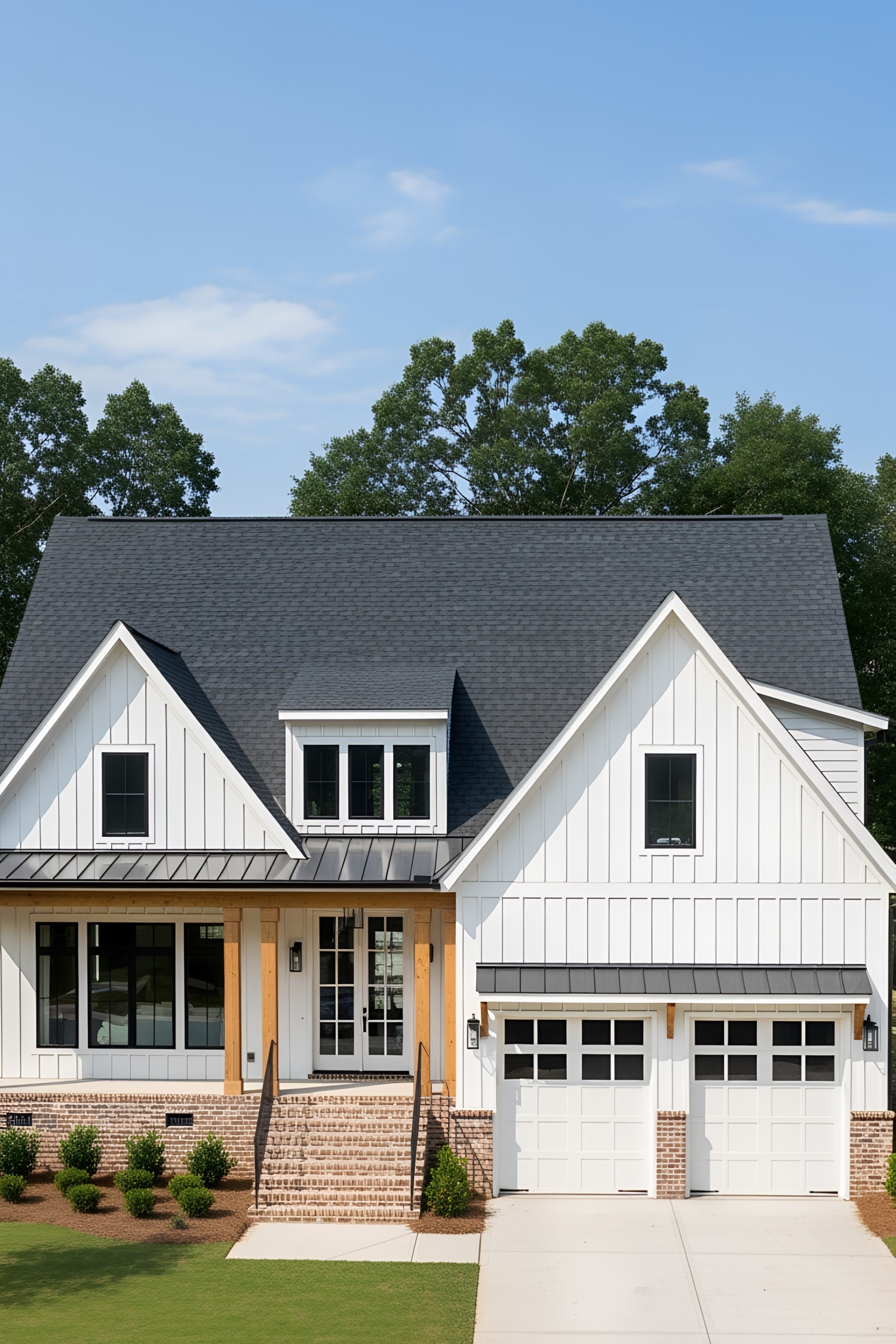 White cottage with two-car garage and charming porch