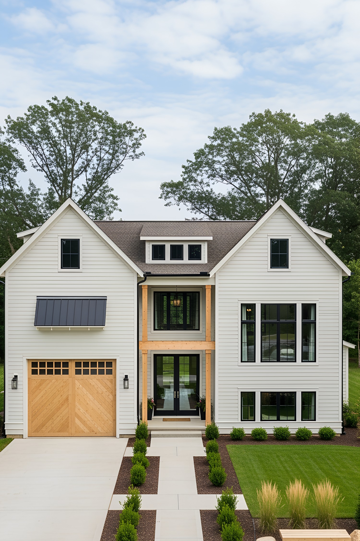 Modern white cottage with wooden garage and lush greenery