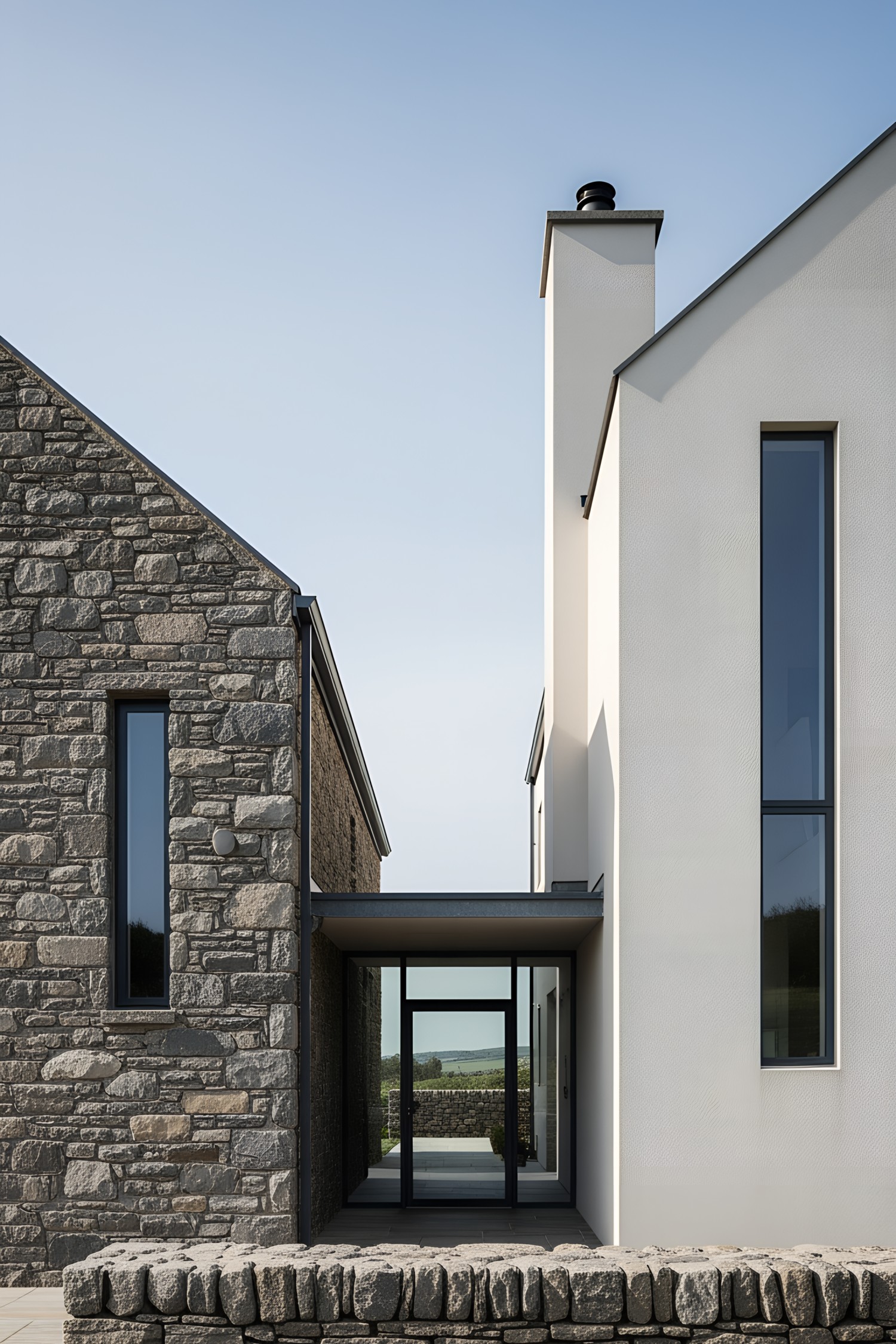 Modern Irish cottage with stone facade and large windows