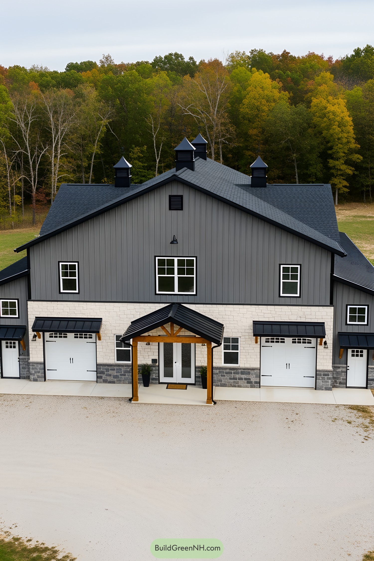 Spacious gray barndominium with multiple gables and stone accents