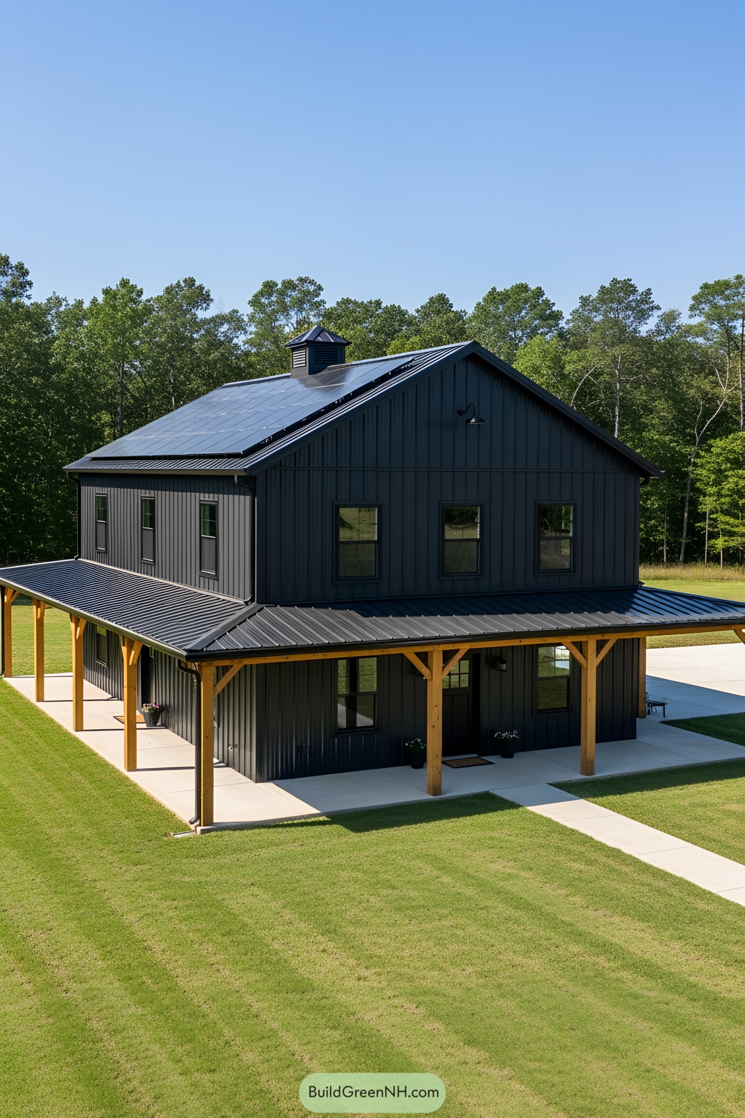 Black barndominium with a wraparound porch