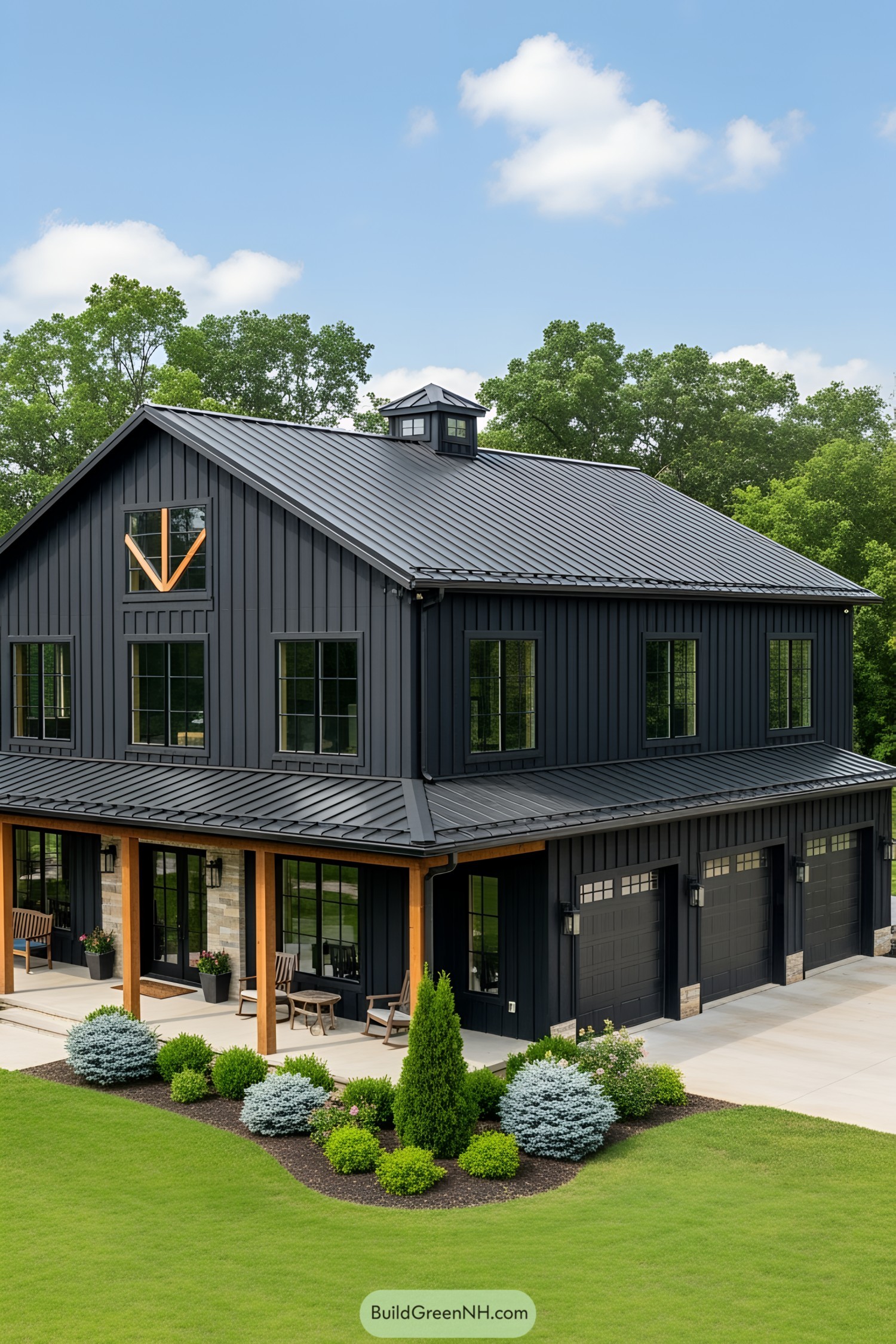 Sleek black barndominium with lush greenery