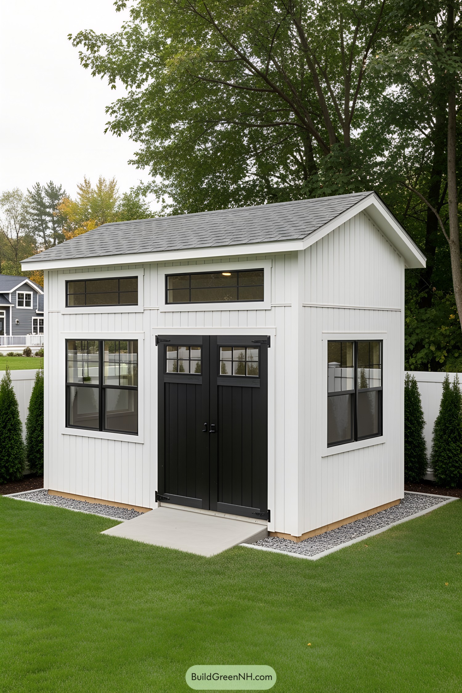 Chic shed with black trim in a green yard