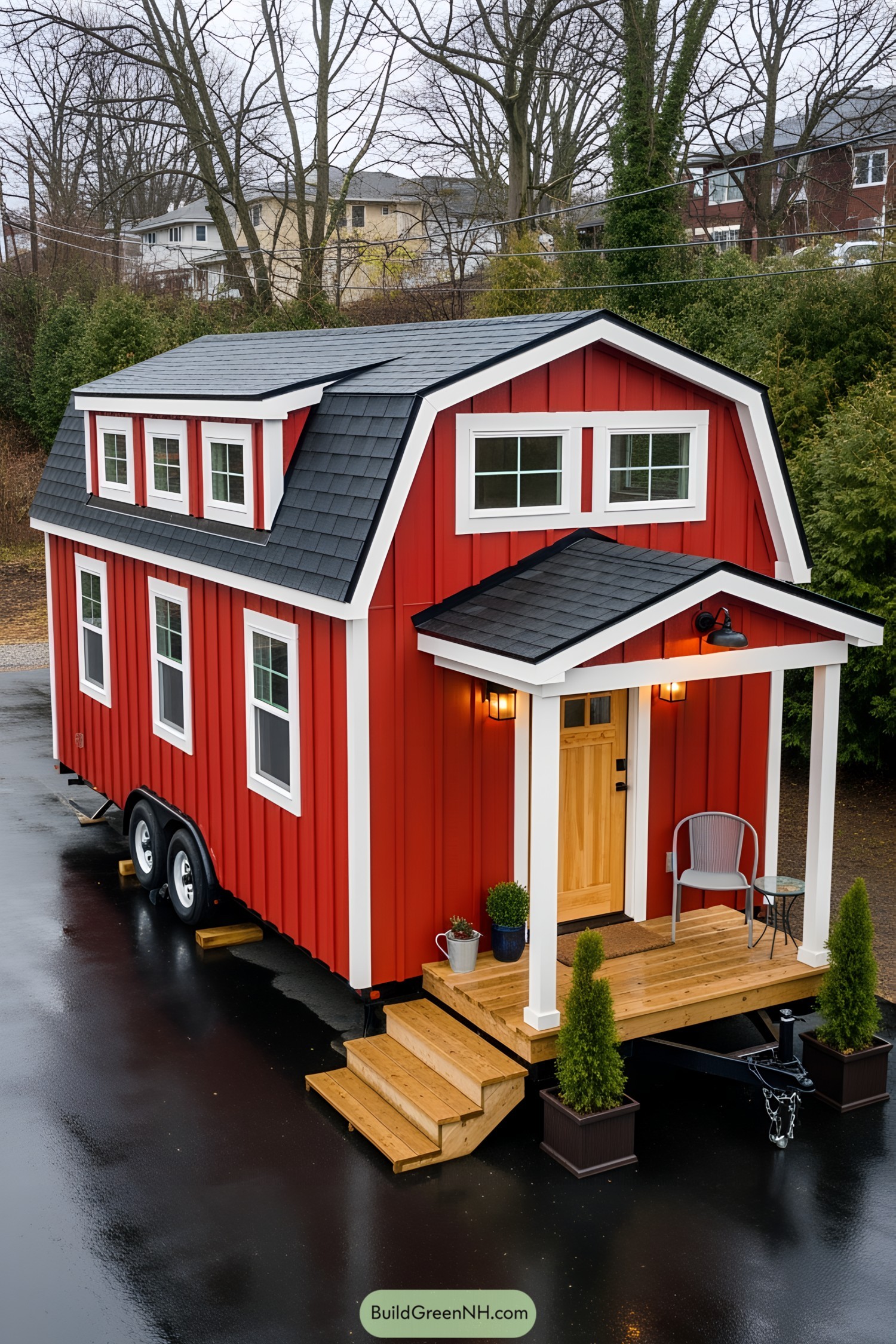 Red barn-style tiny house with a porch
