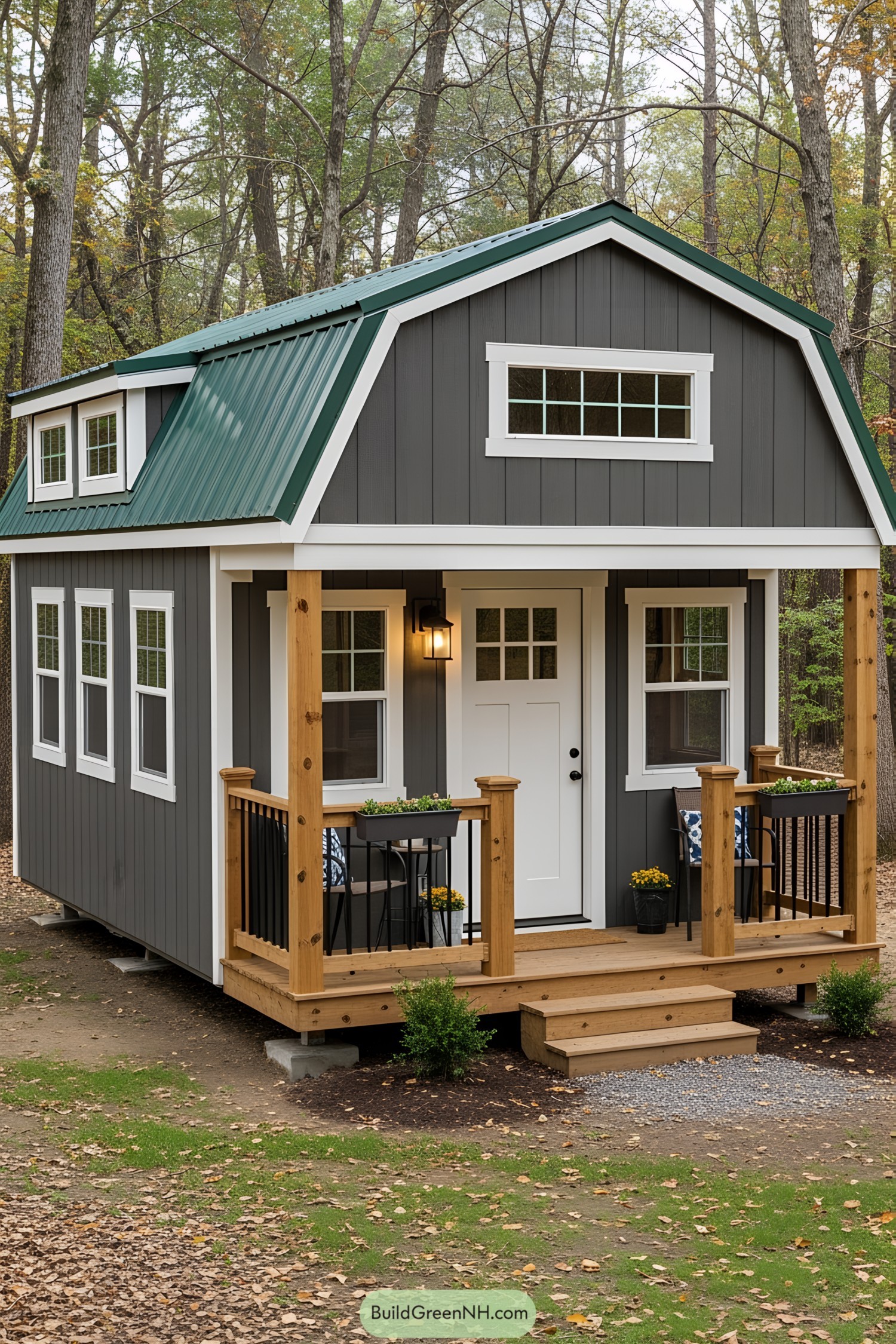 Cozy gray barn shed with green roof amid trees