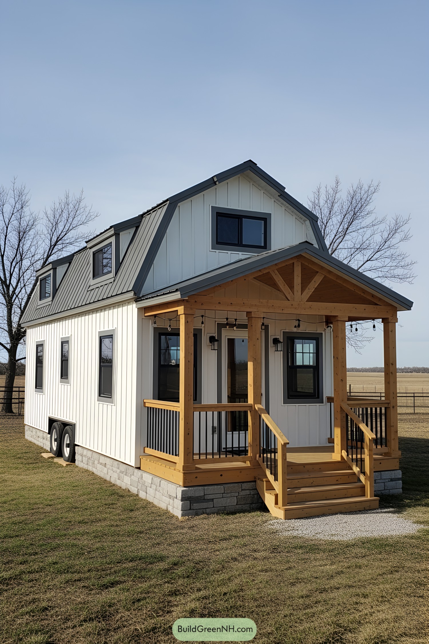 White barn-style tiny house with a wooden porch