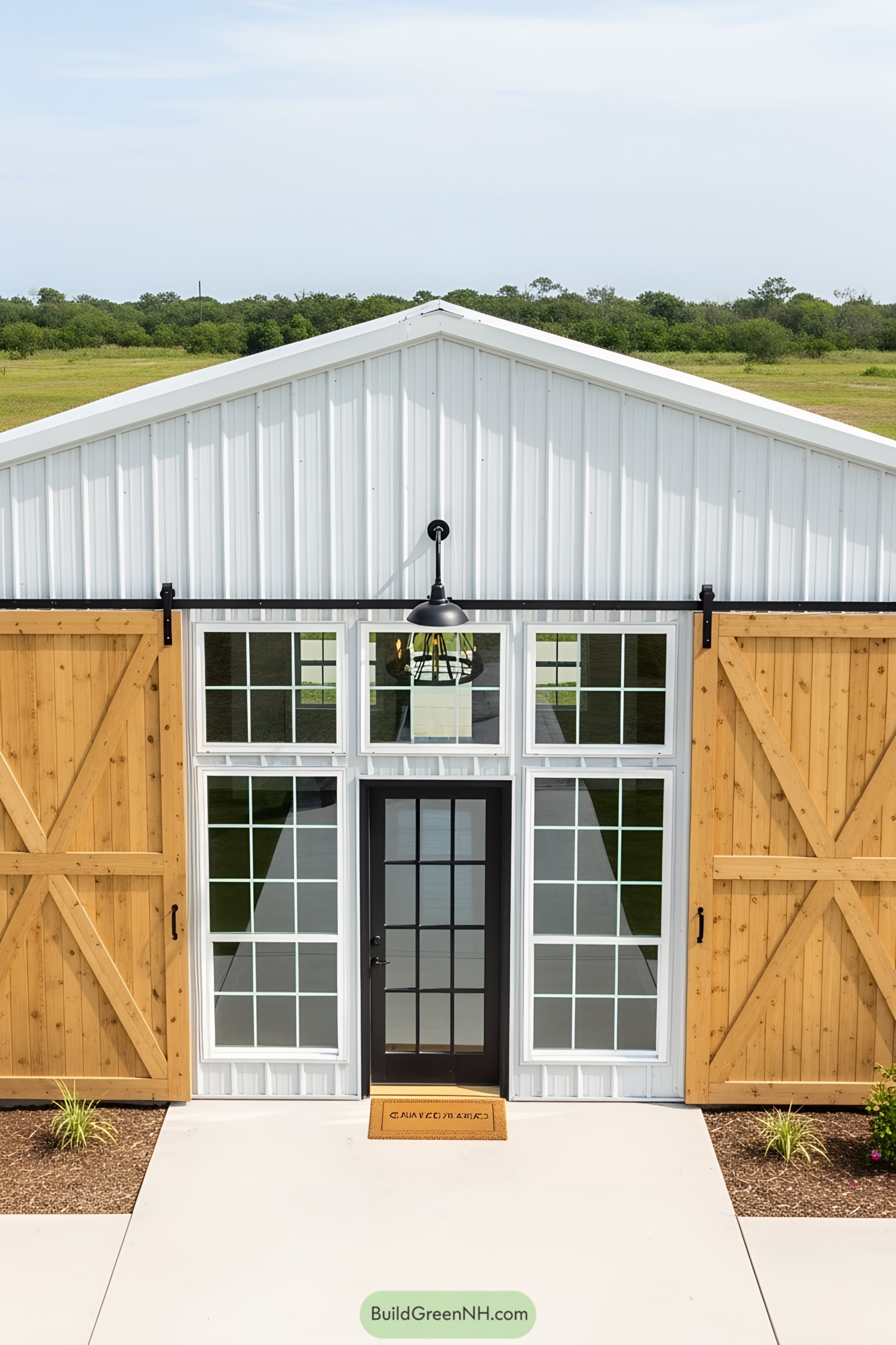 Modern barn house with large sliding doors and glass entry