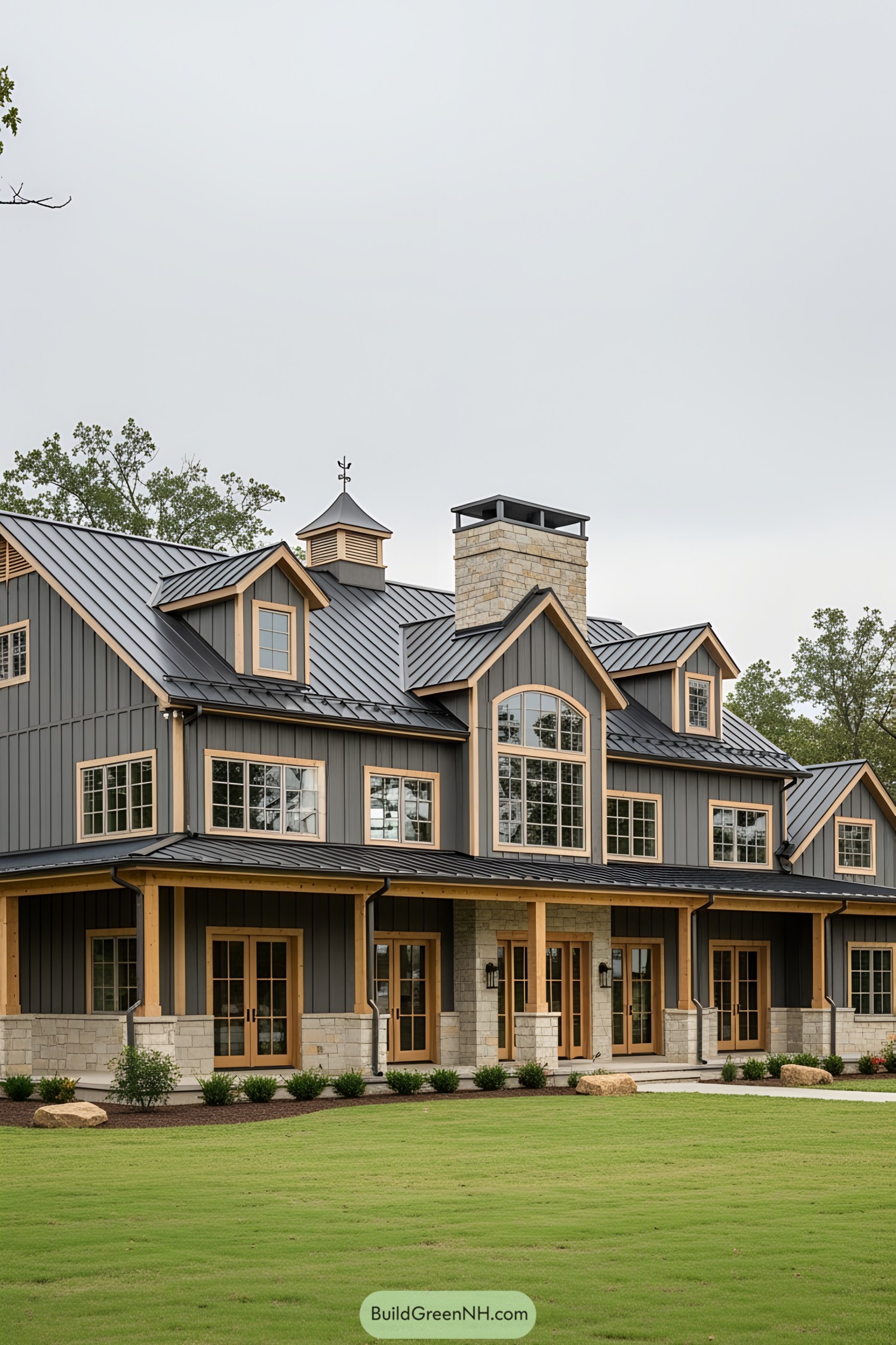 Modern barn-style mansion with large windows and lush lawn