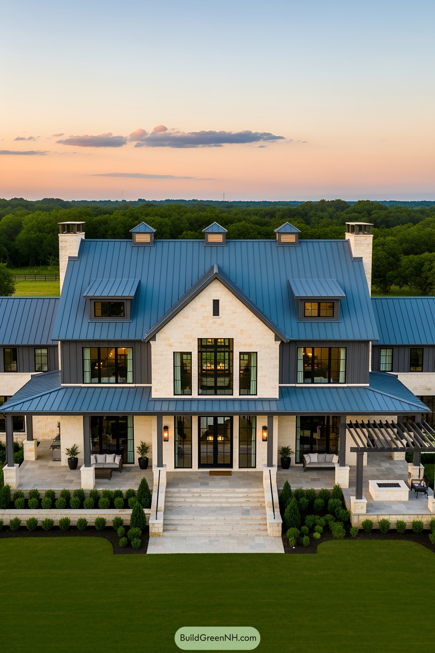 Elegant country barndominium mansion with blue roof at sunset