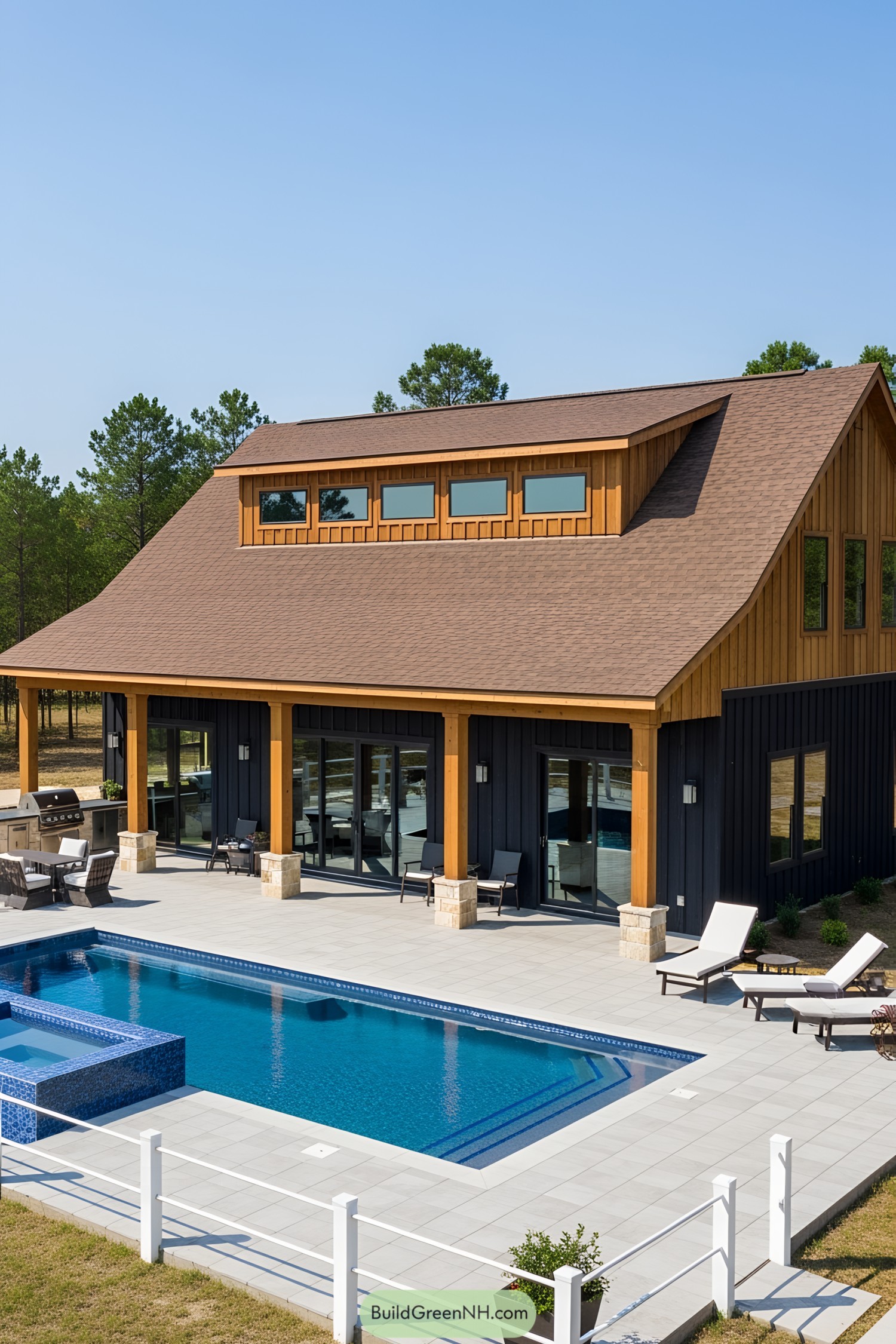 Barndominium with a pool and patio, surrounded by trees