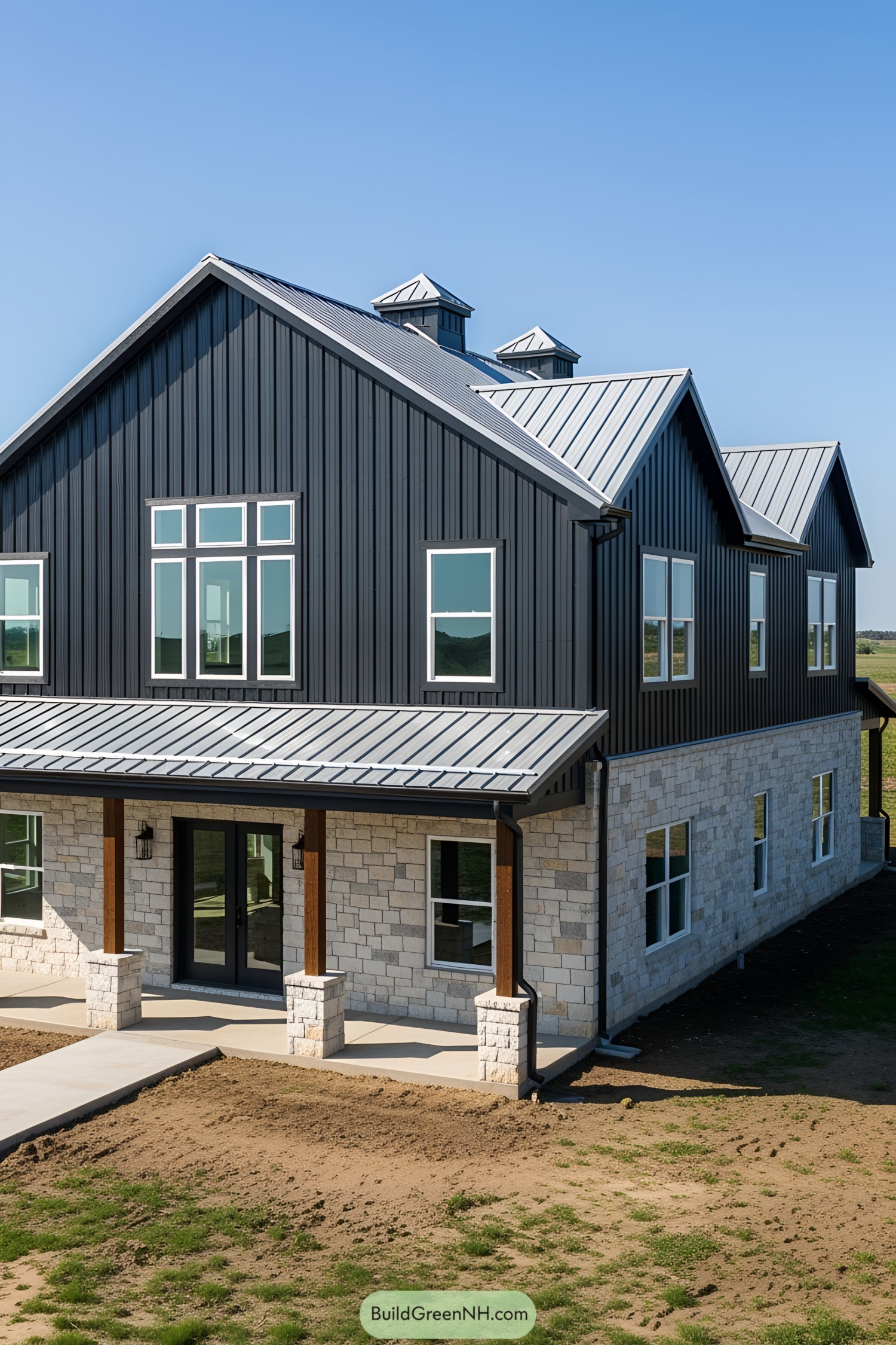 Black barndominium with stone detailing and large windows
