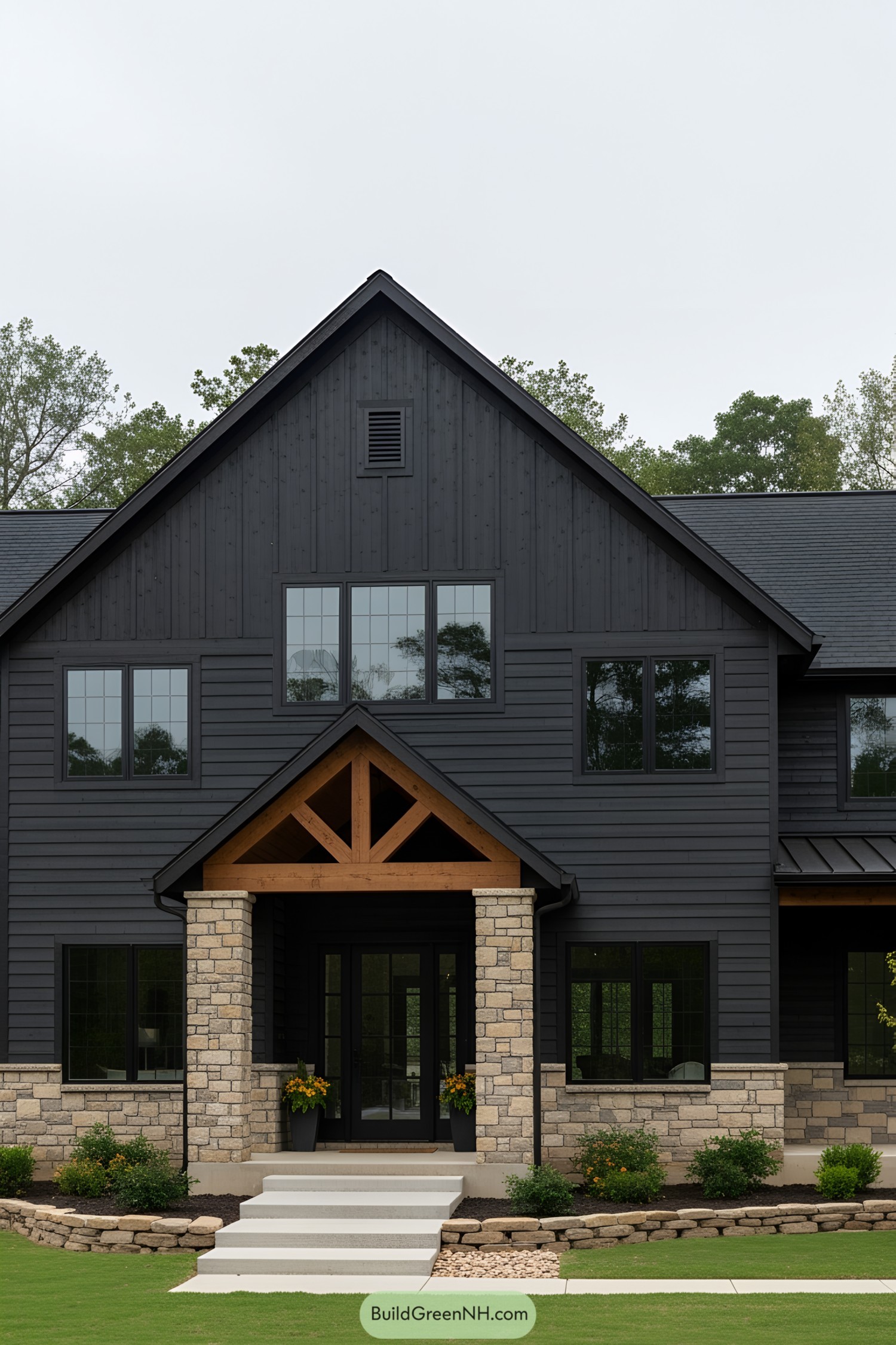 Black barndominium with stone accents and wooden details
