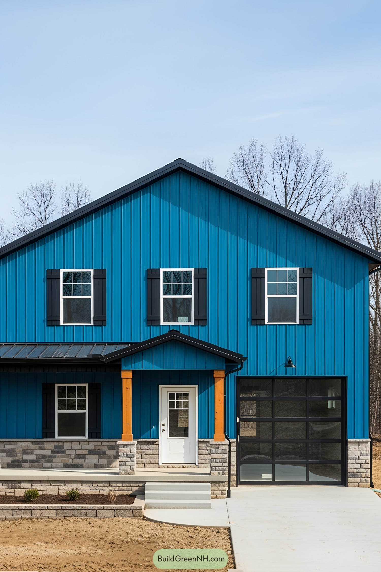 Blue barndominium with black shutters and garage