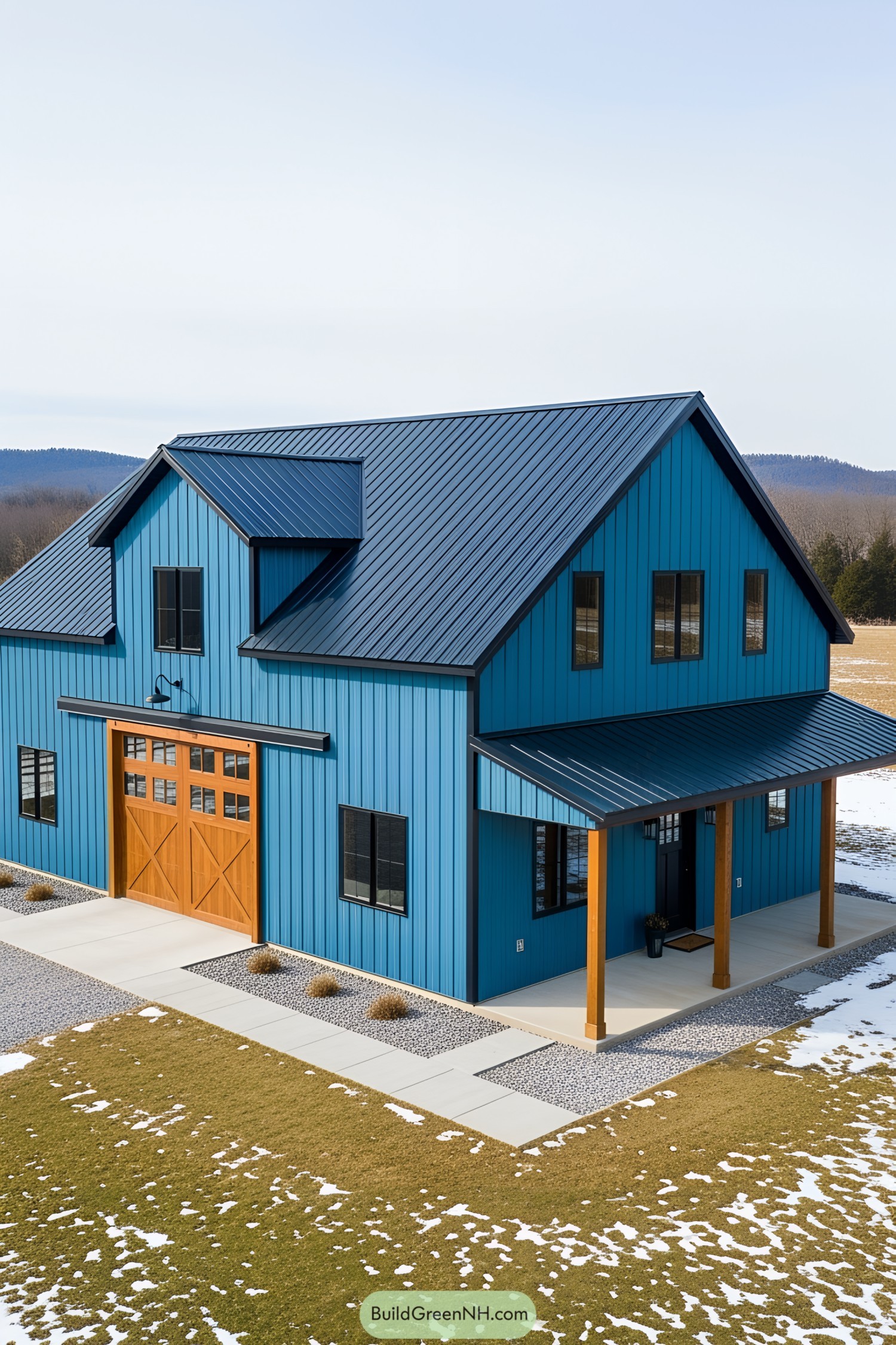 Blue barnhouse with wooden accents surrounded by snow and grass