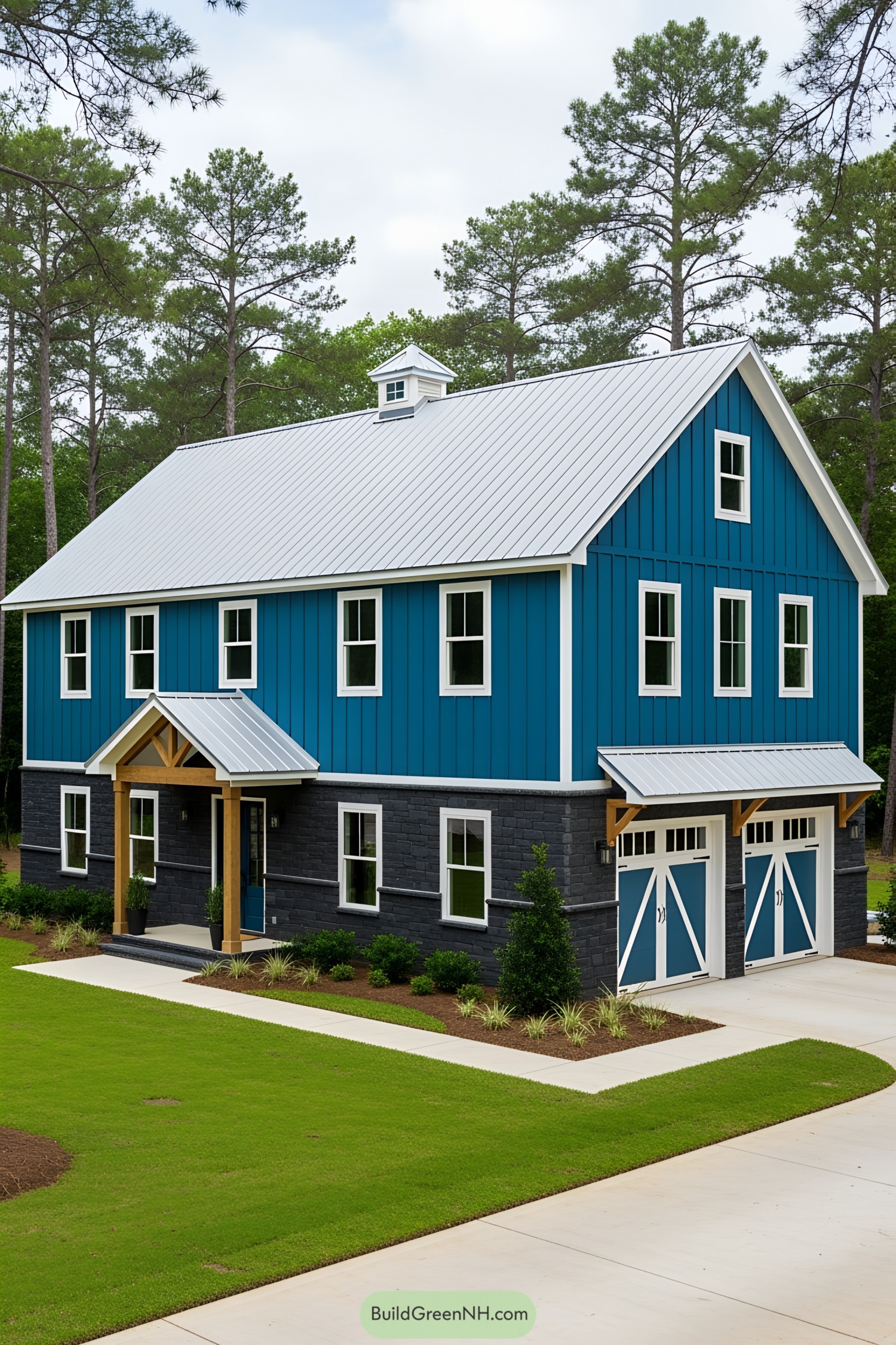 A vibrant blue barndominium with a white roof and quaint surroundings