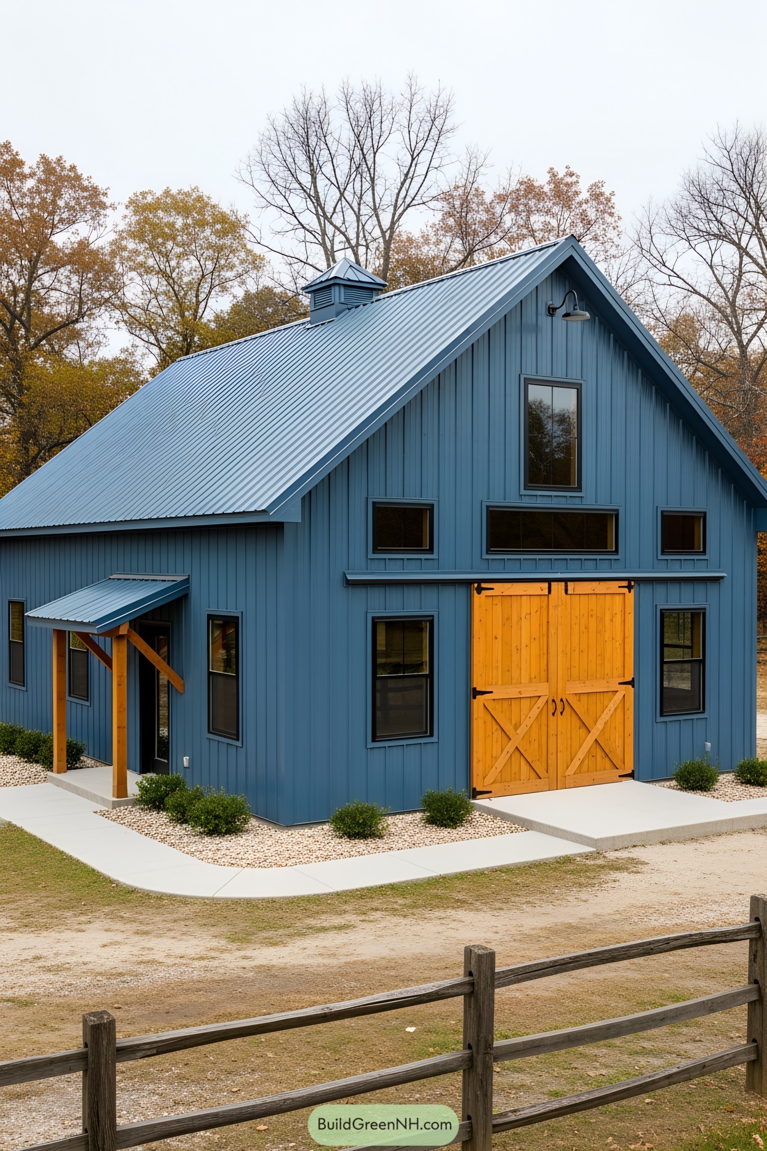 A blue barndominium with wooden barn doors