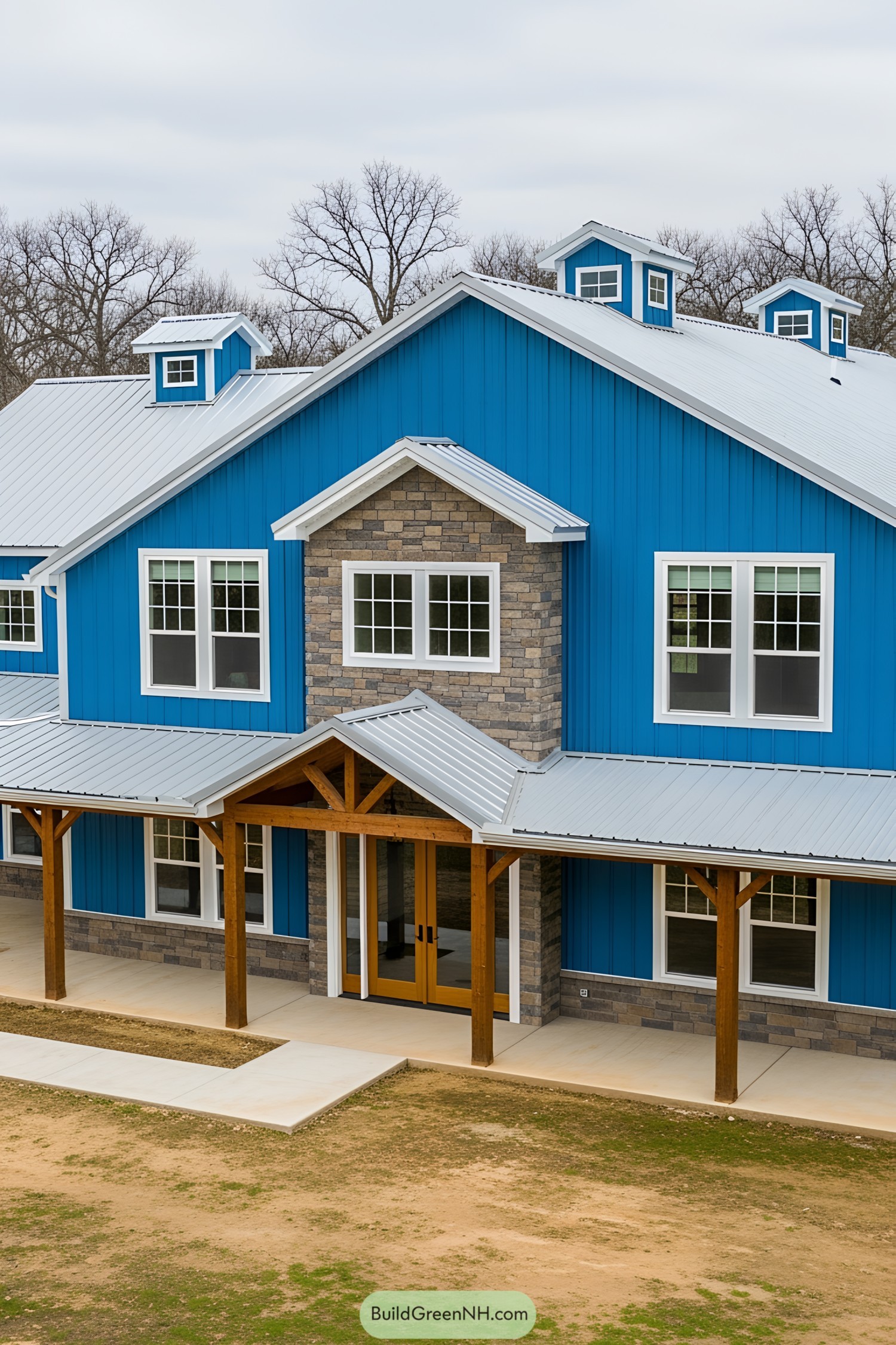 Striking blue barndominium with wooden accents