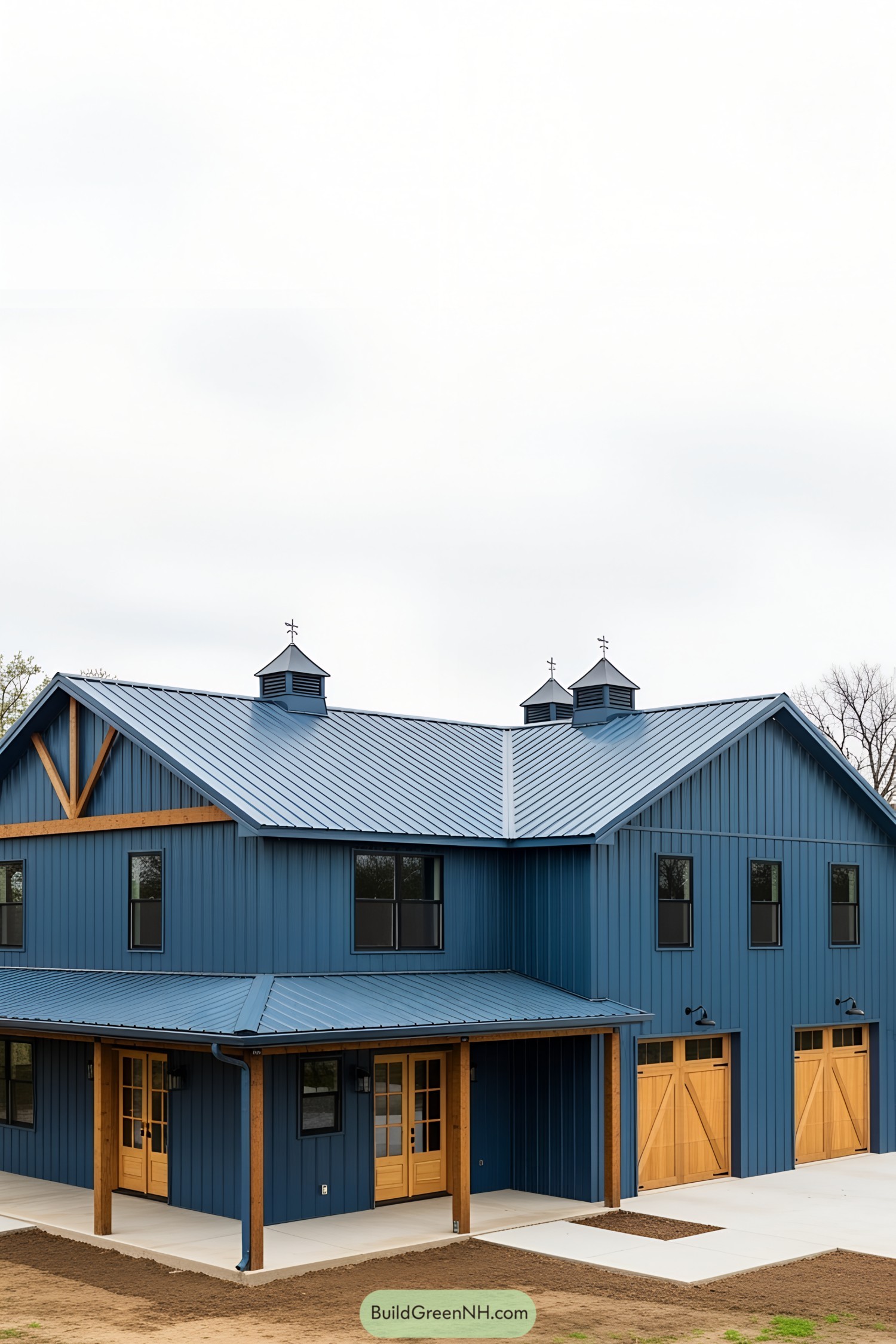 A striking blue barndominium with natural wood accents