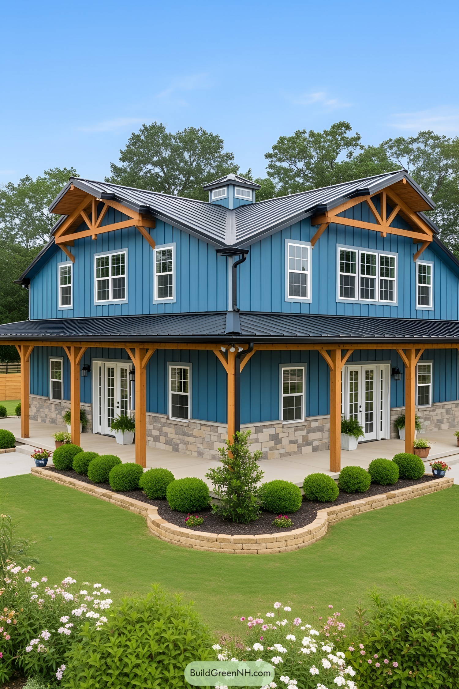 Blue barndominium with wooden accents surrounded by lush greenery
