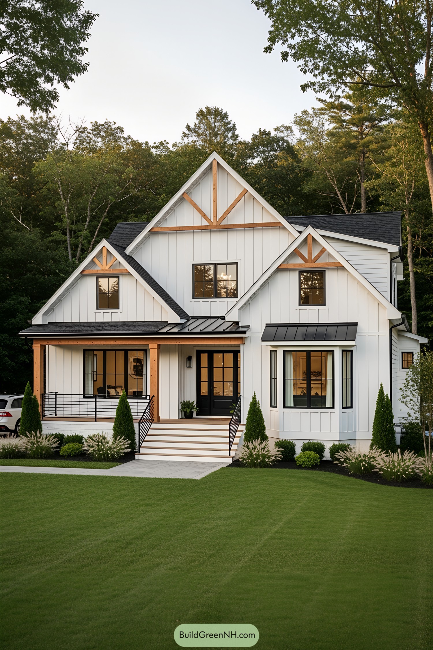 White farmhouse with black accents and green lawn