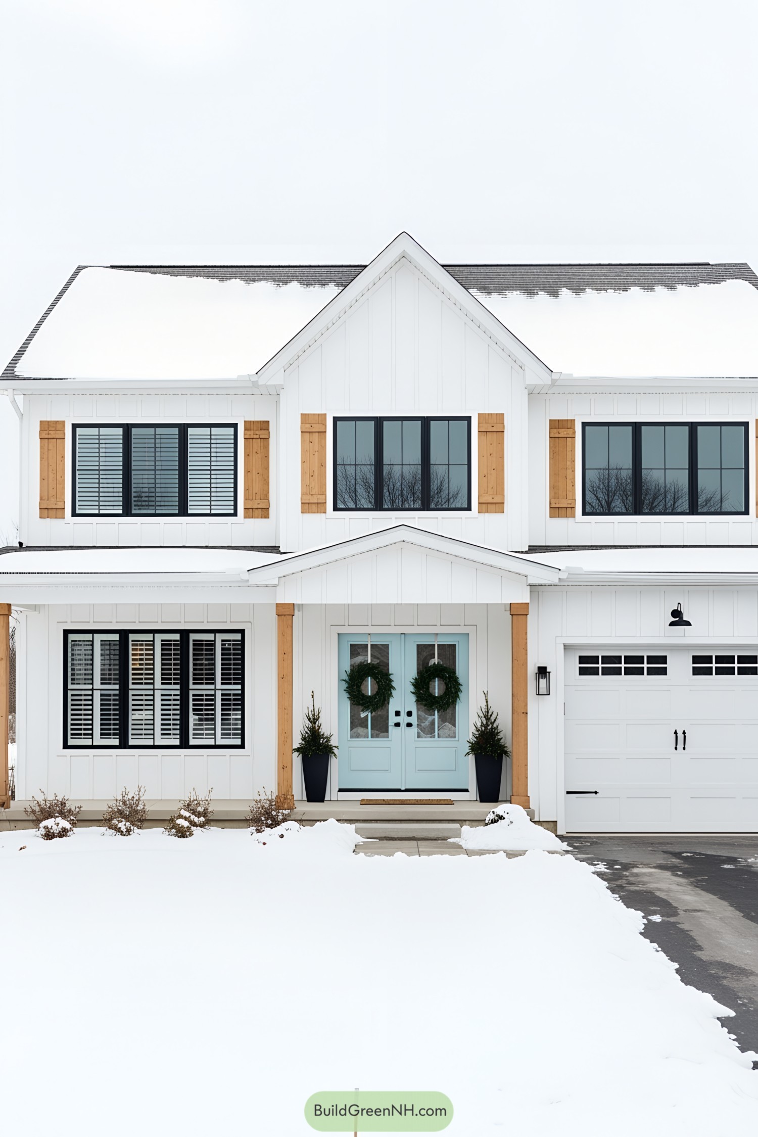 Charming white farmhouse with wooden shutters and a mint door