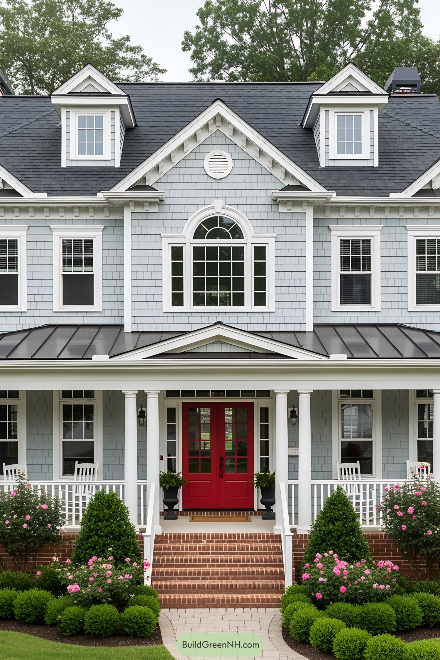 Front view of a charming suburban house with a vibrant red door