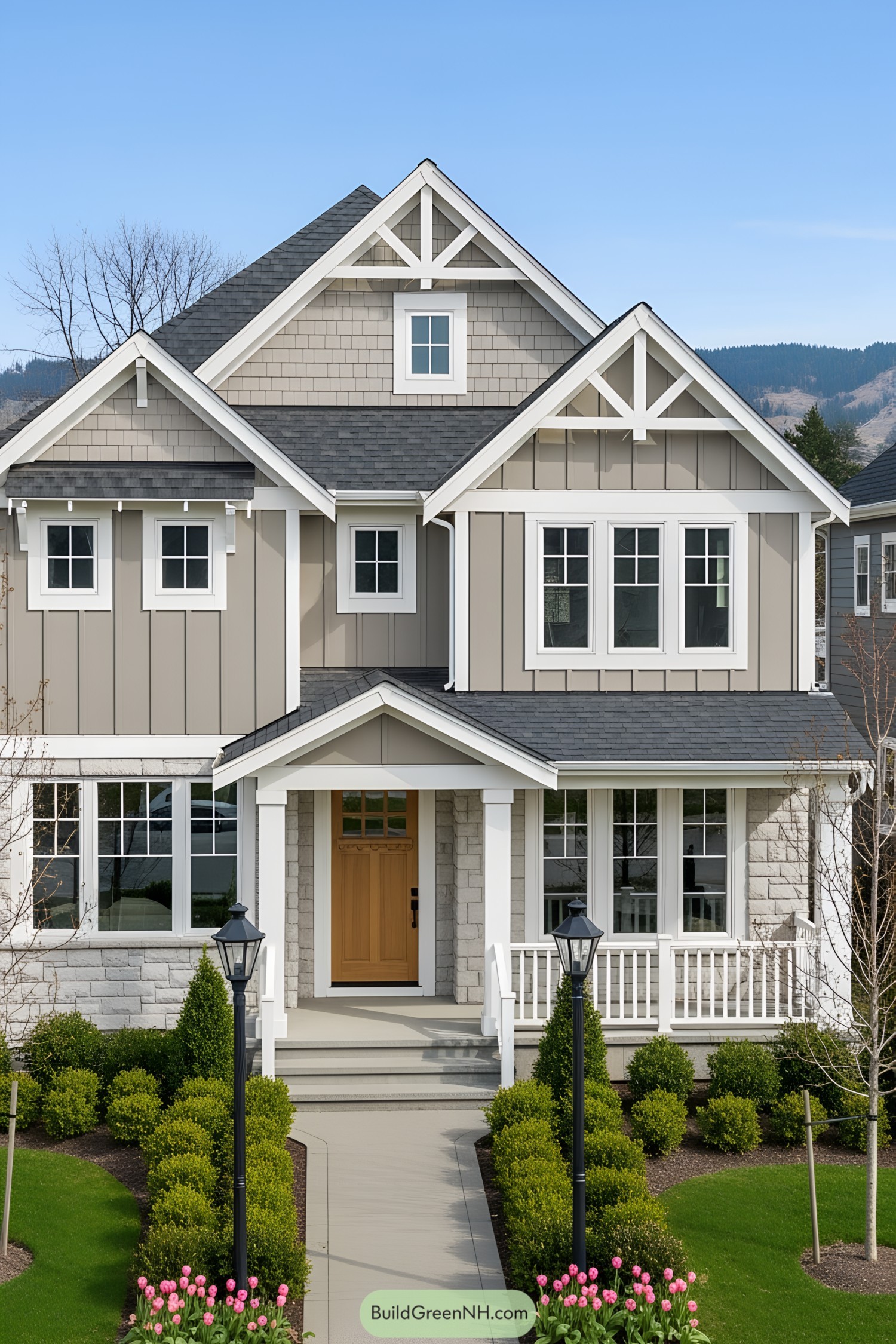 Two-story suburban house with a welcoming porch and trim landscaping