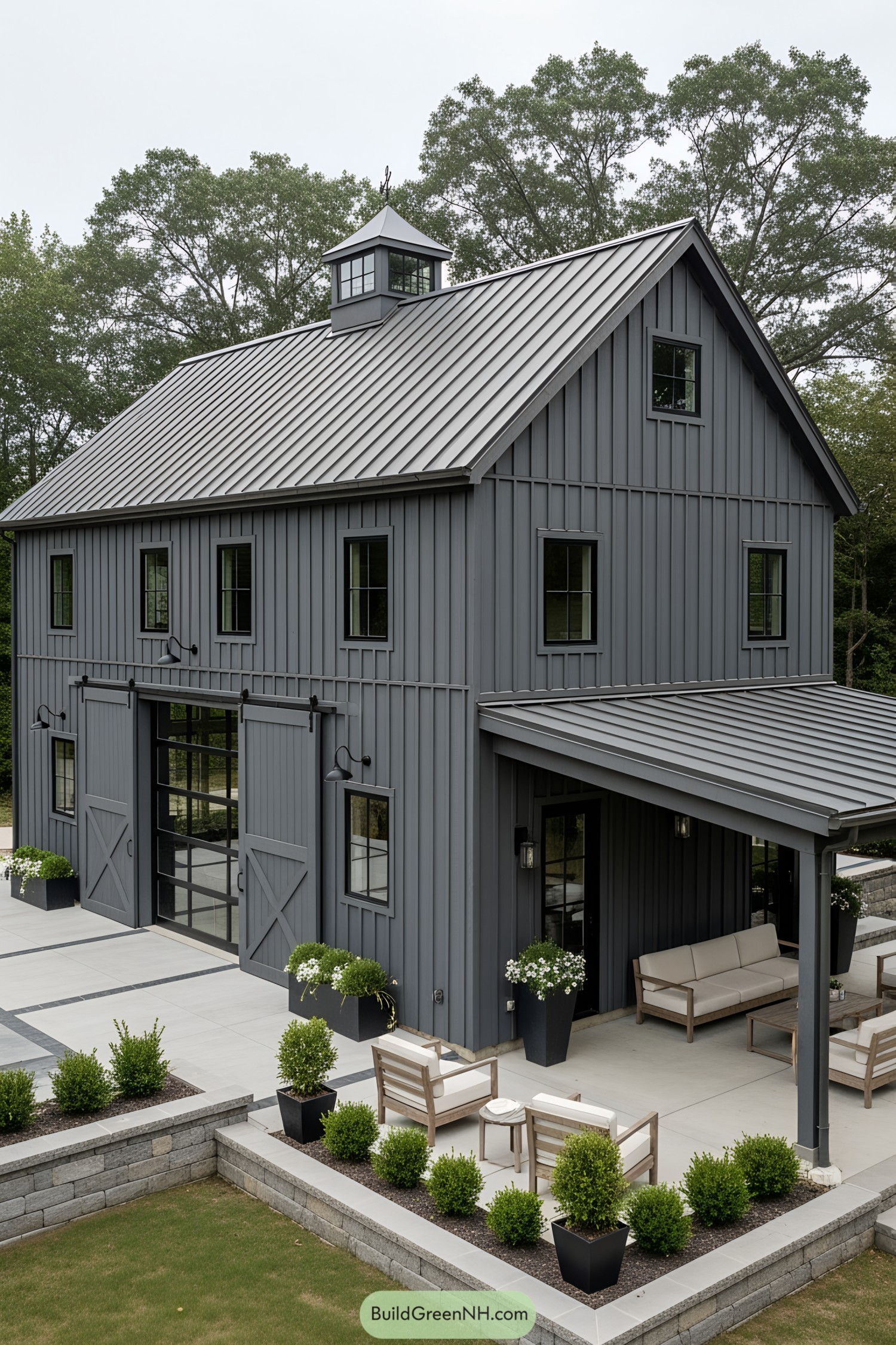 Dark gray barn house with lush greenery