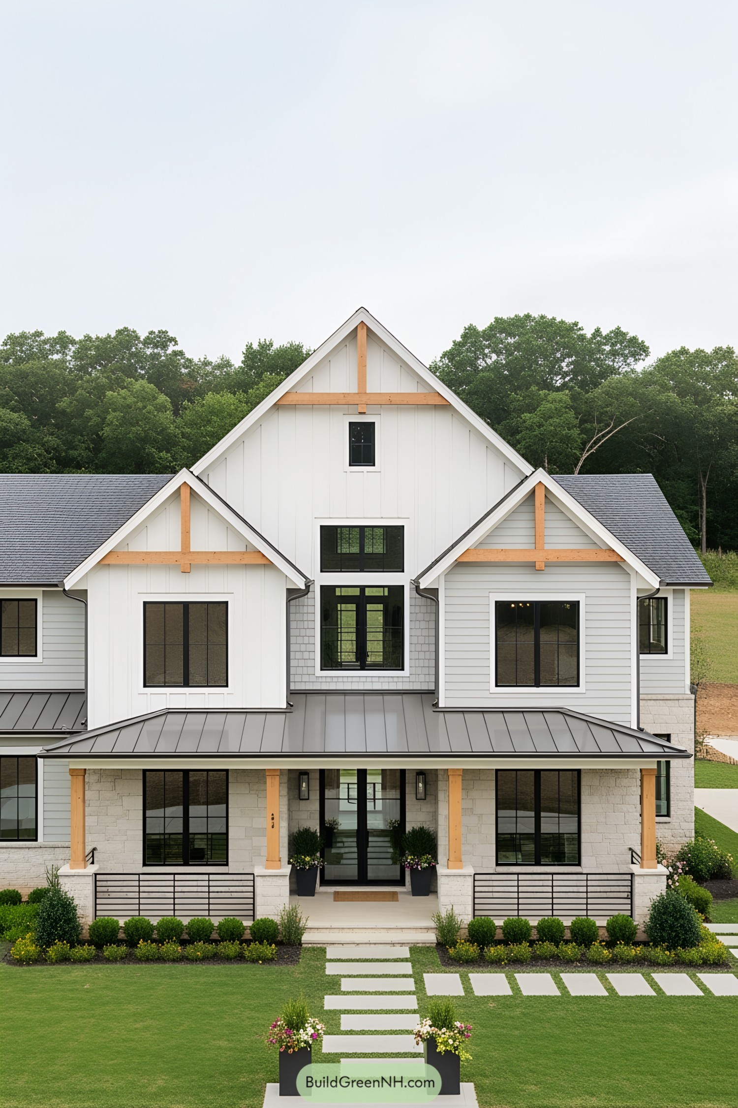 Modern white farmhouse with gabled roof and manicured lawn
