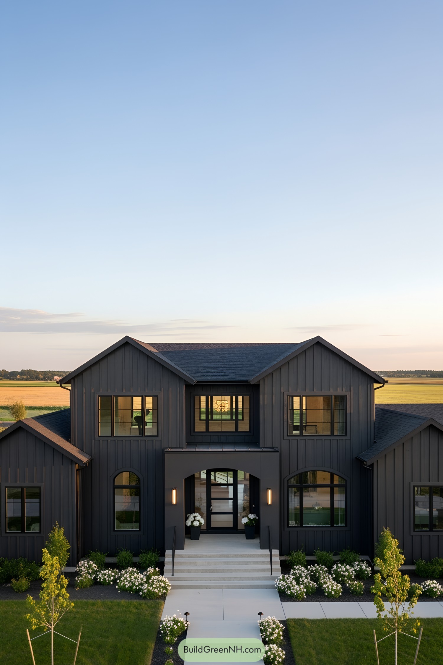 Stylish modern farmhouse with black exterior and lush lawn