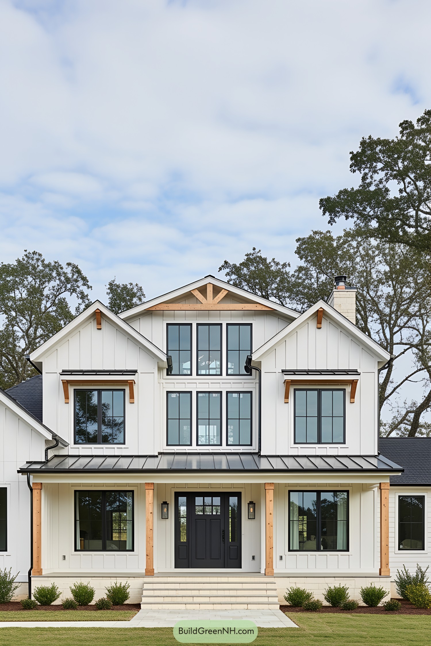 Modern farmhouse with a black roof and large windows