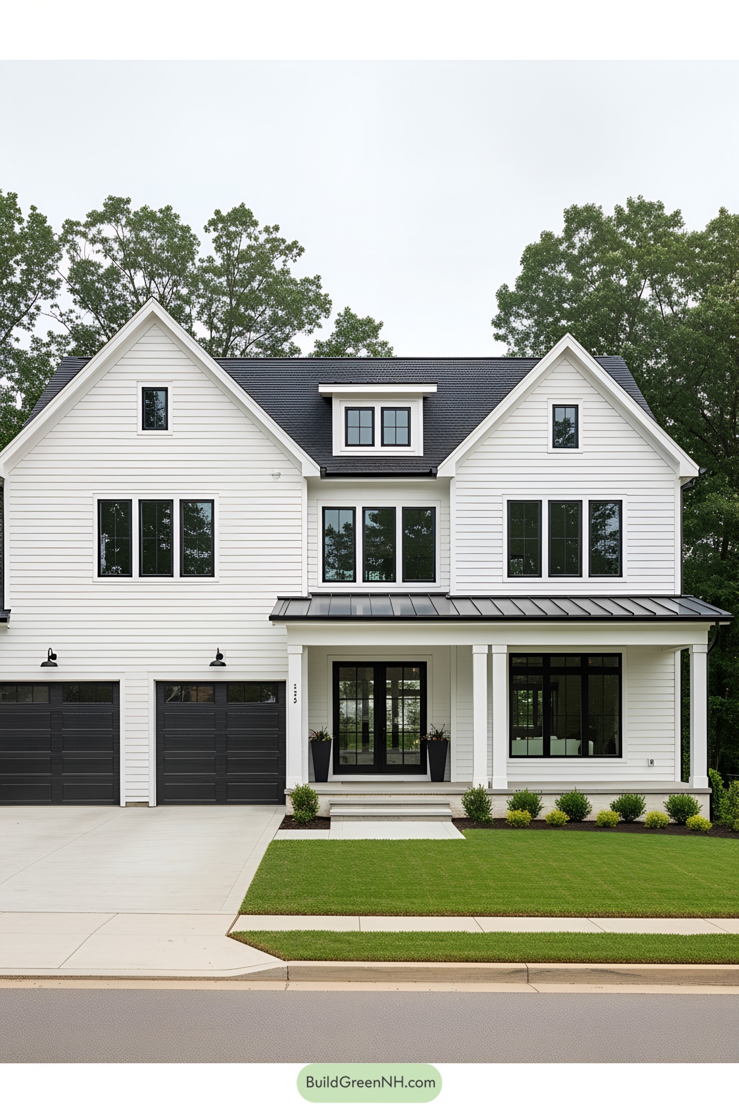 Elegant white farmhouse with black accents and lush green lawn