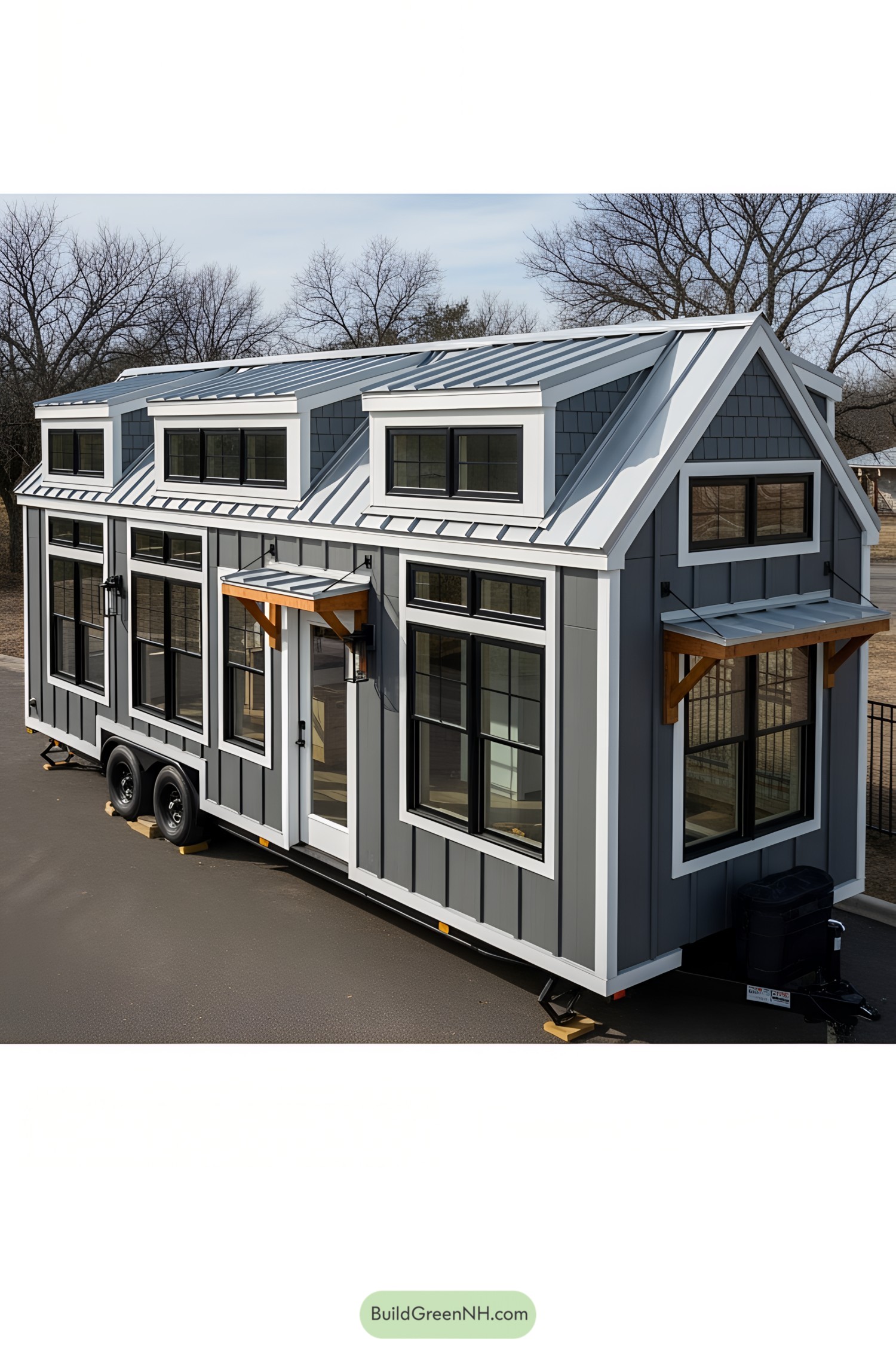 Compact farmhouse-style tiny house on wheels with dormers and large windows
