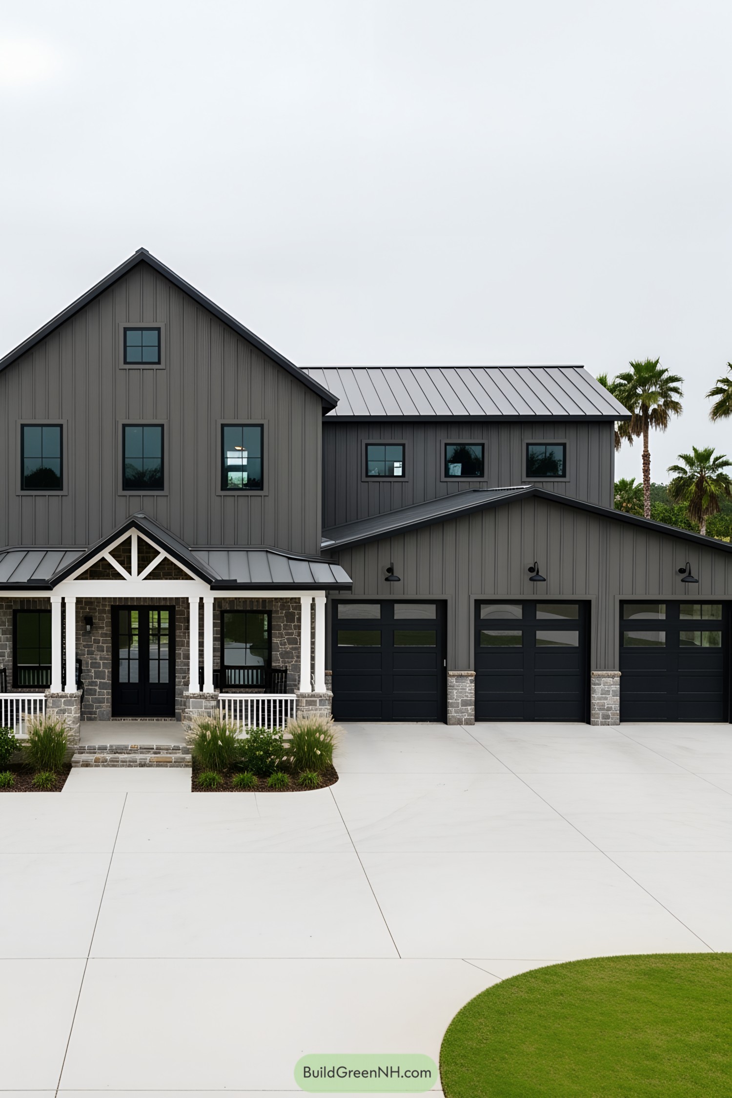 Large modern barndominium with gray siding and a porch