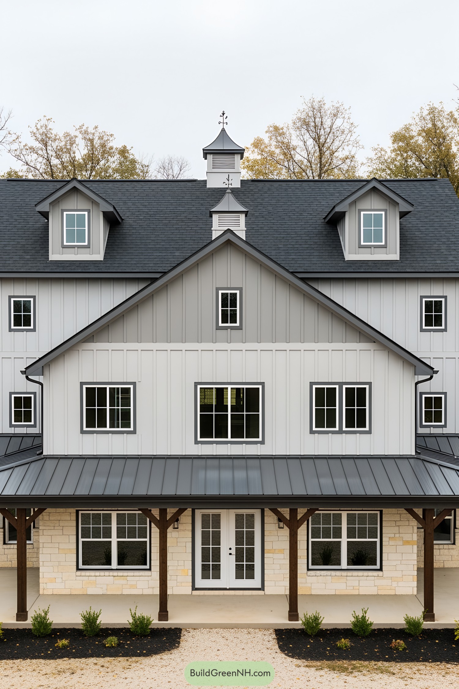 Gray barndominium with symmetrical windows and wooden accents
