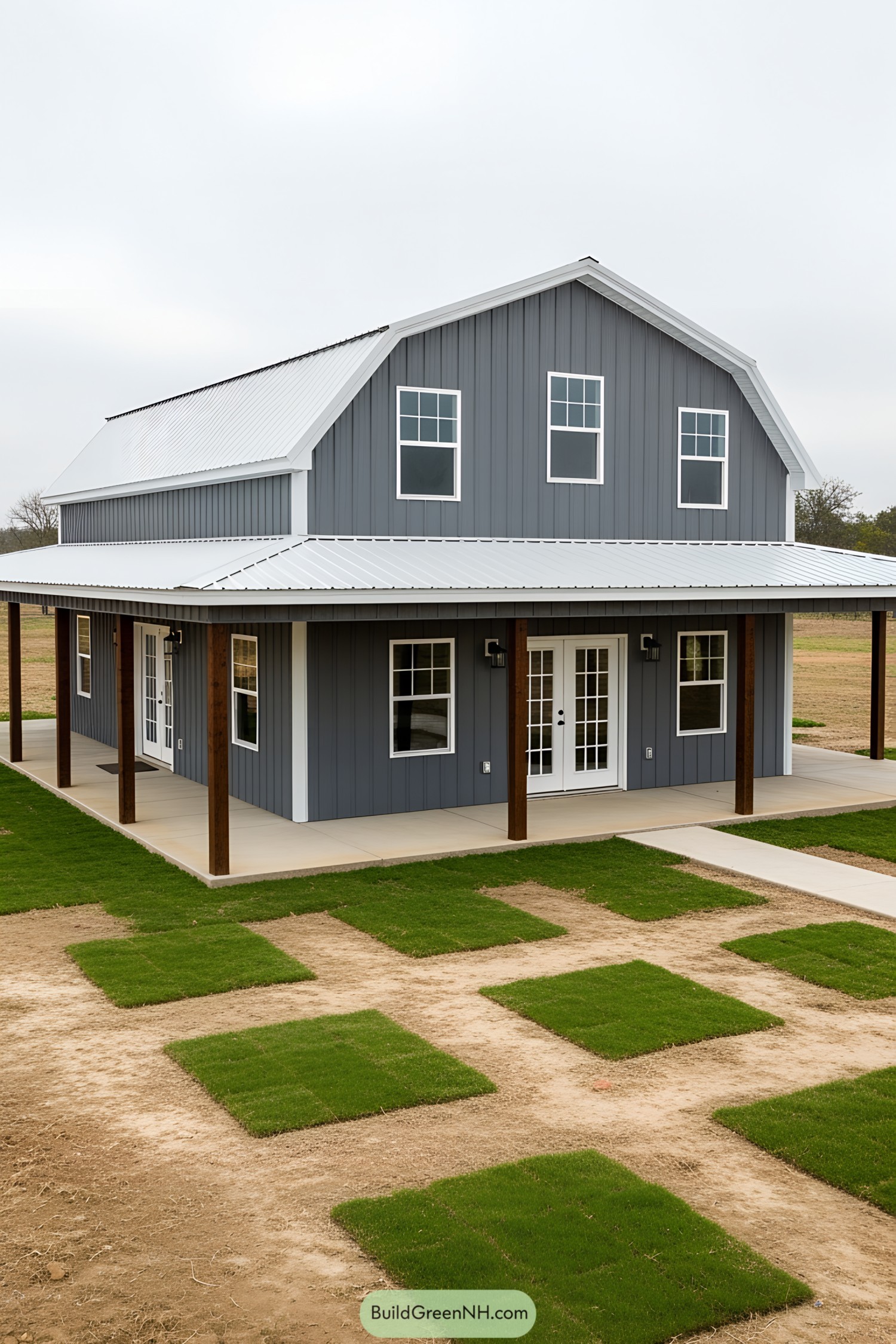 Gray barndominium with white roof and porch