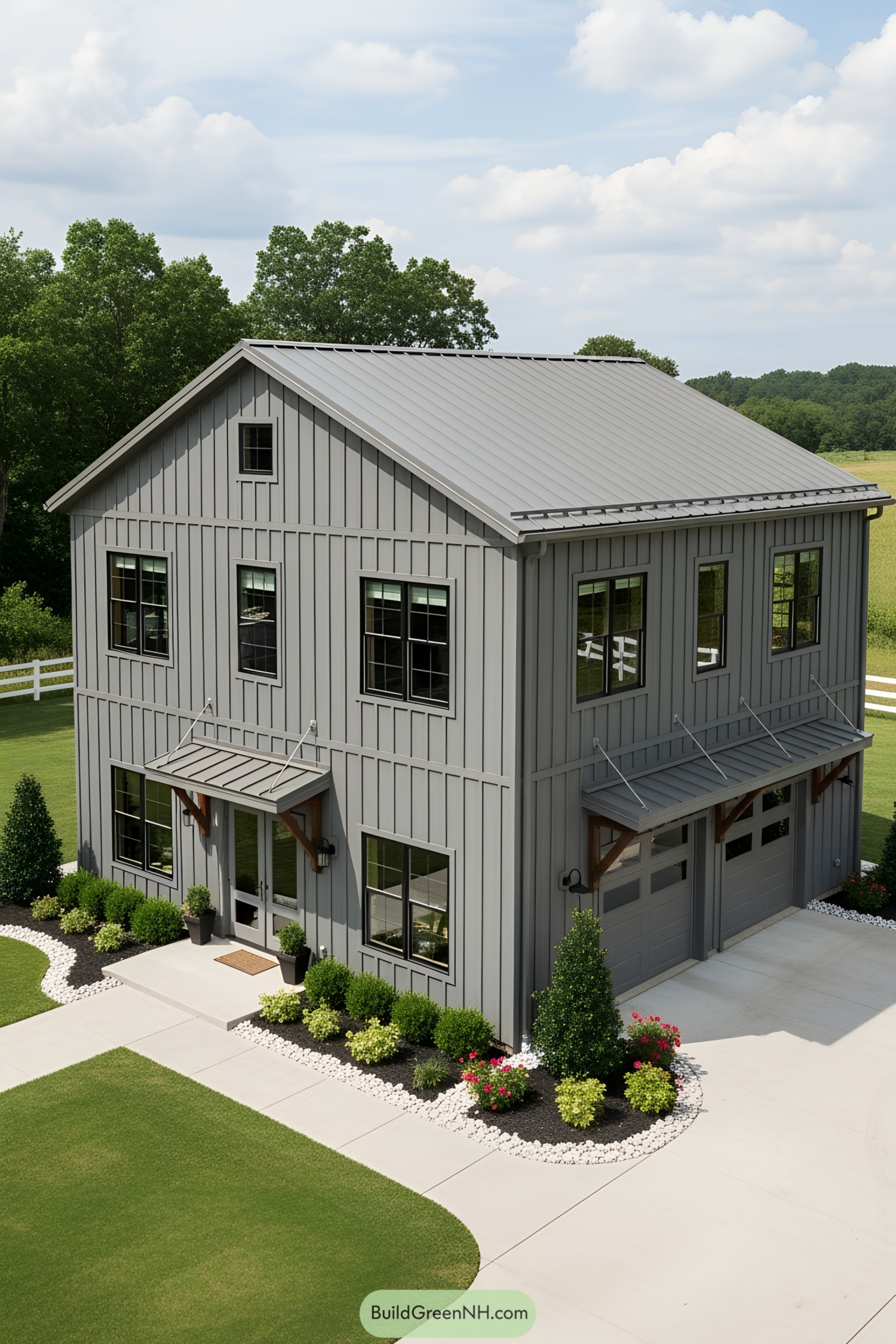 A two-story gray barndominium with a metal roof and large windows