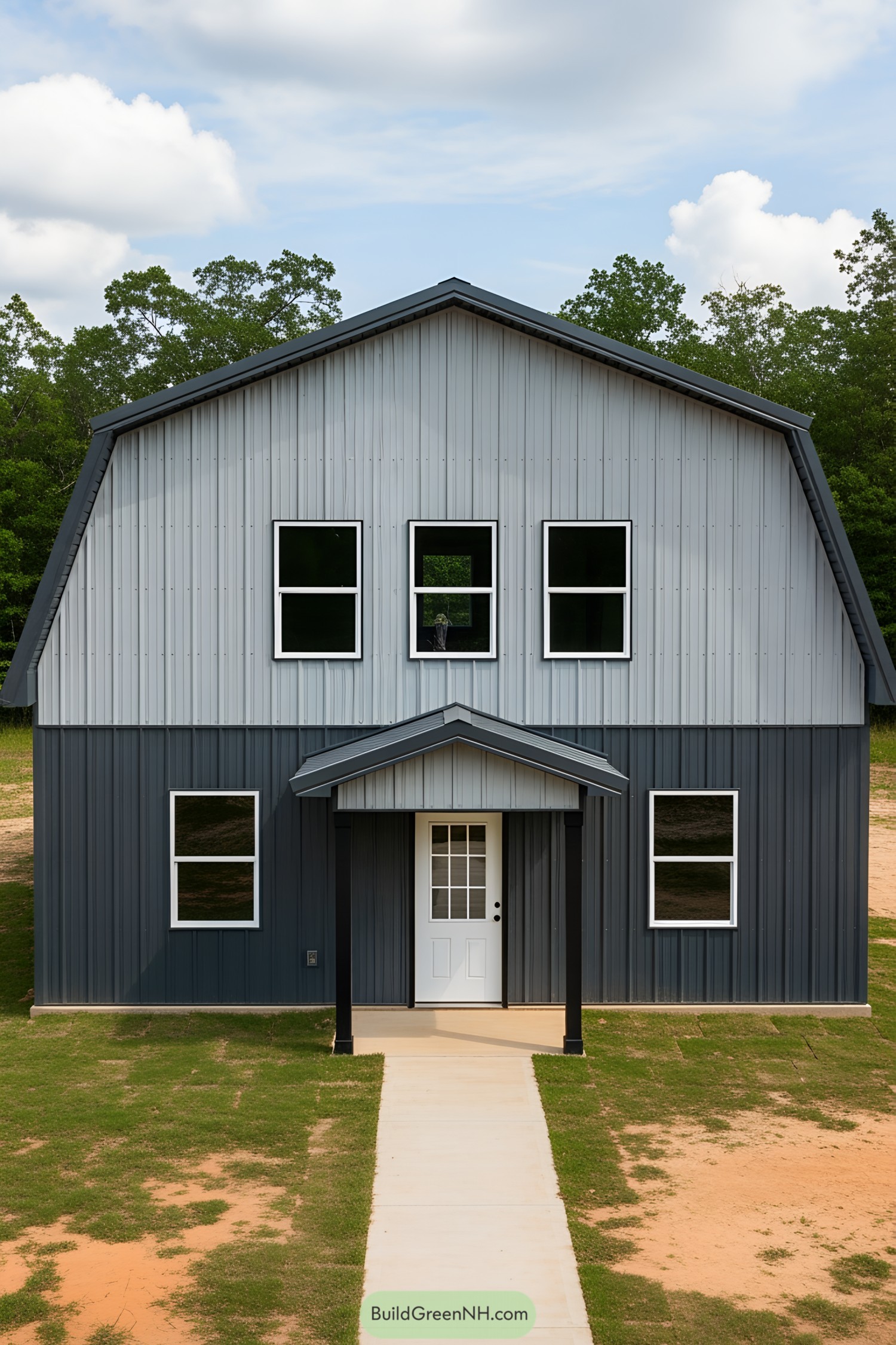 Gray barndominium with symmetrical windows and door