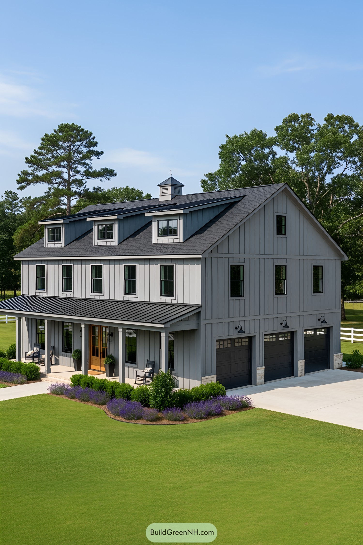 Gray barndominium with three garage doors and lush lawn