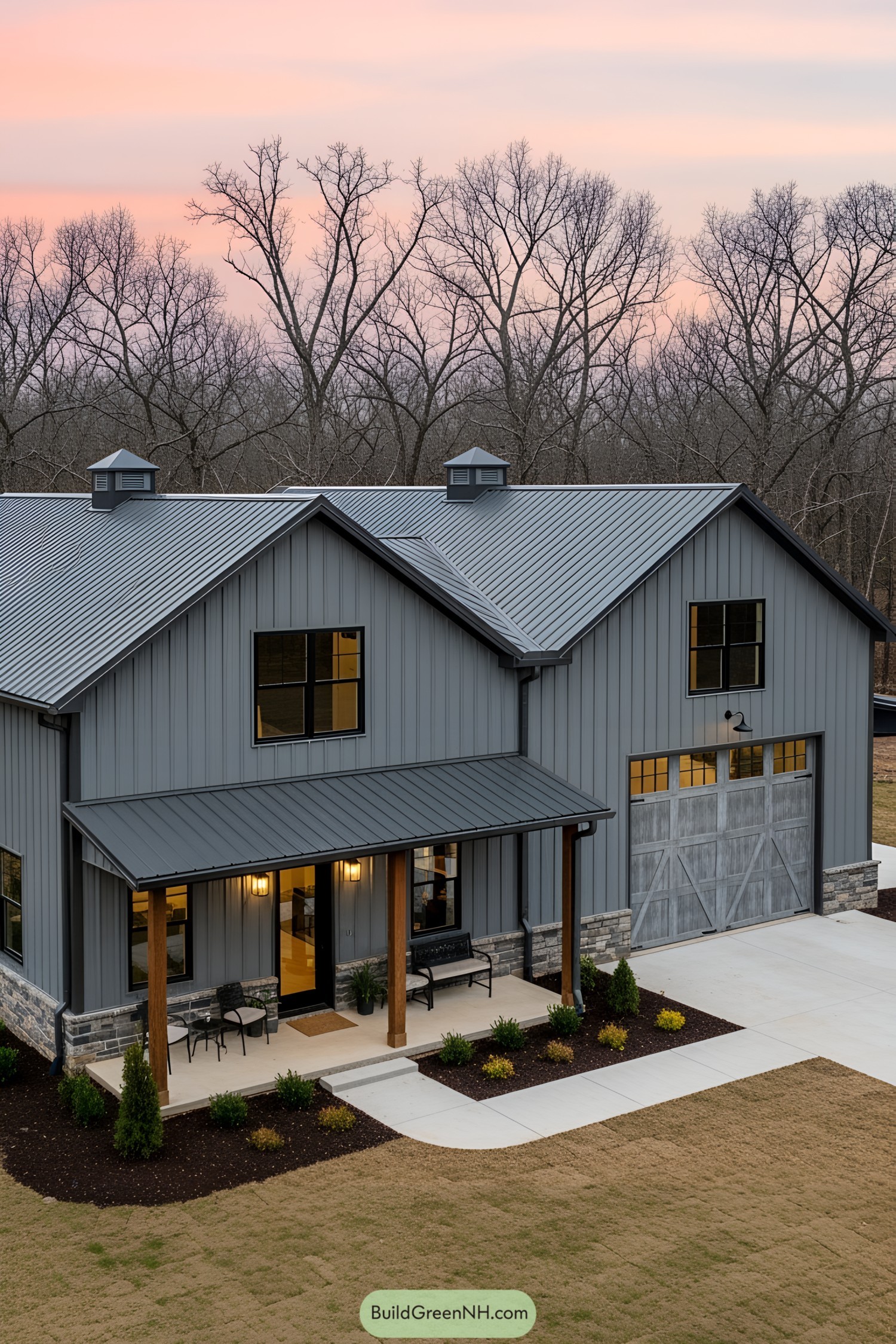 Gray barndominium with a modern twist under a pink sky