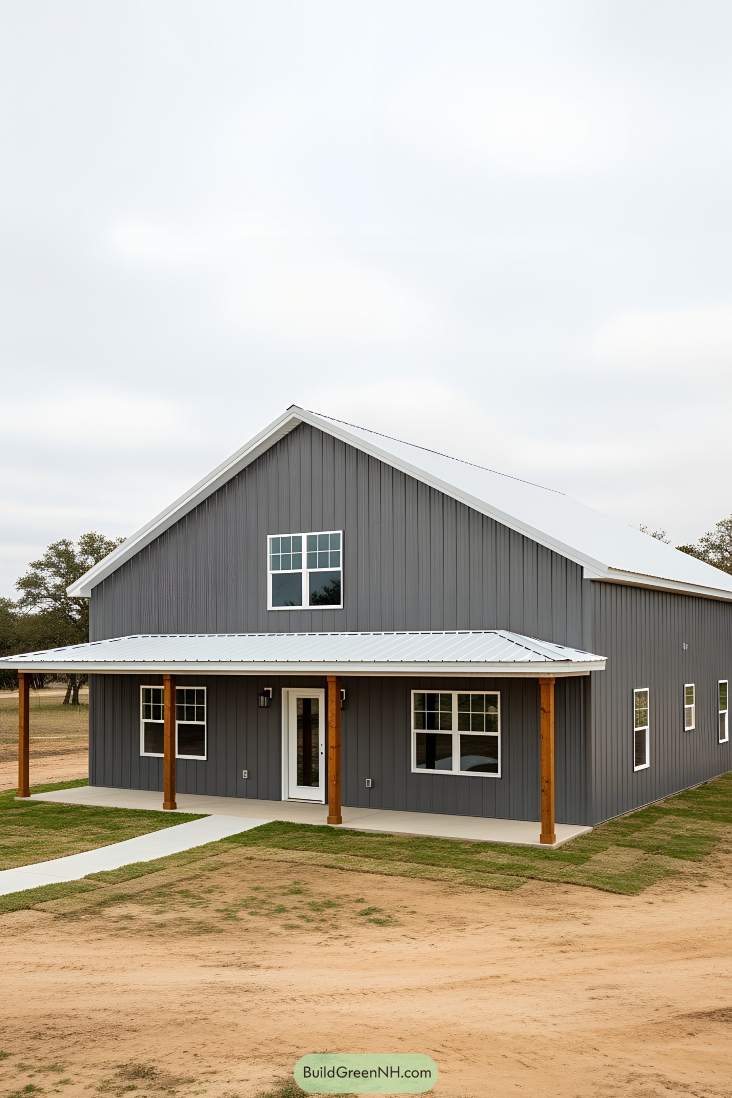 Gray barndominium with white roof and wooden posts