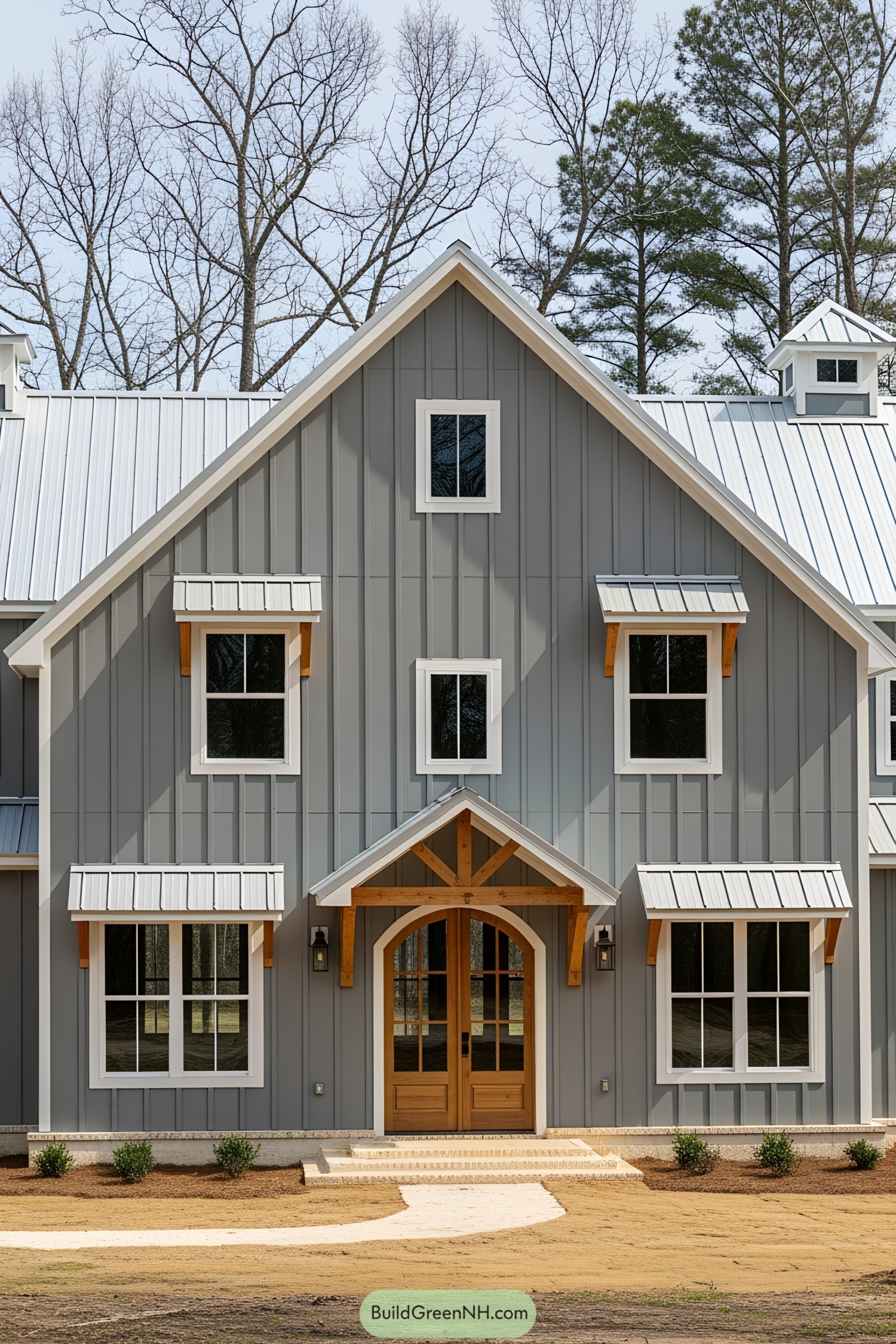 Gray barndominium with wooden accents and metal roof