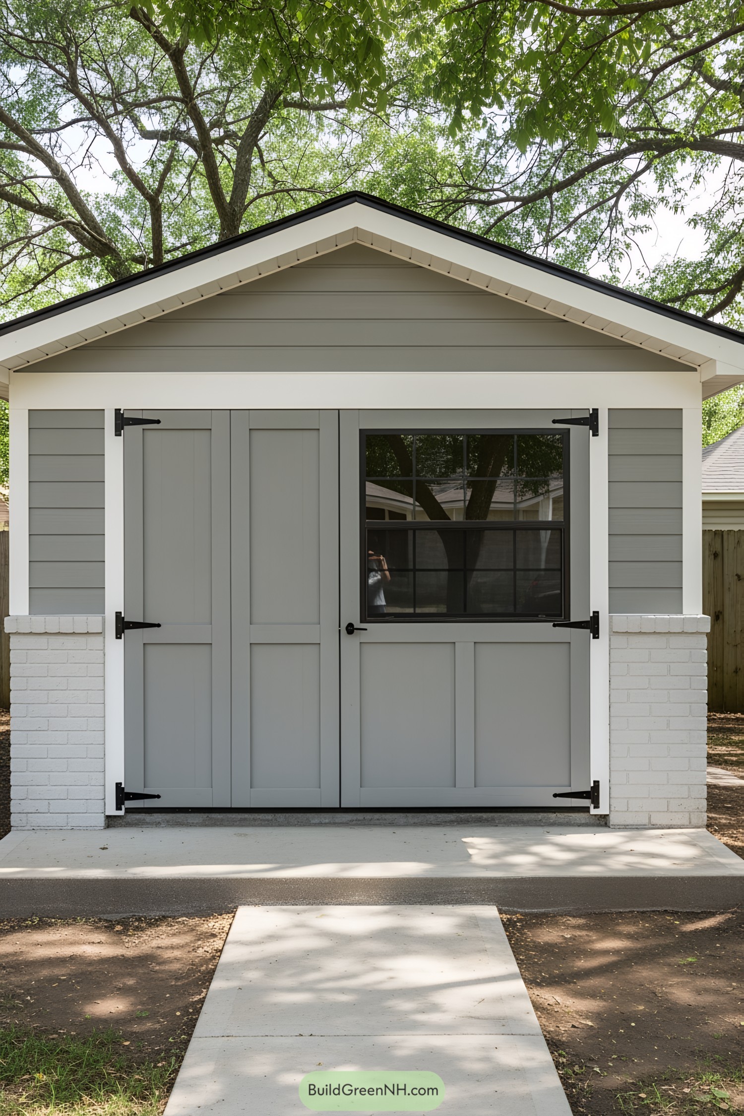 Modern shed with gray siding and white accents
