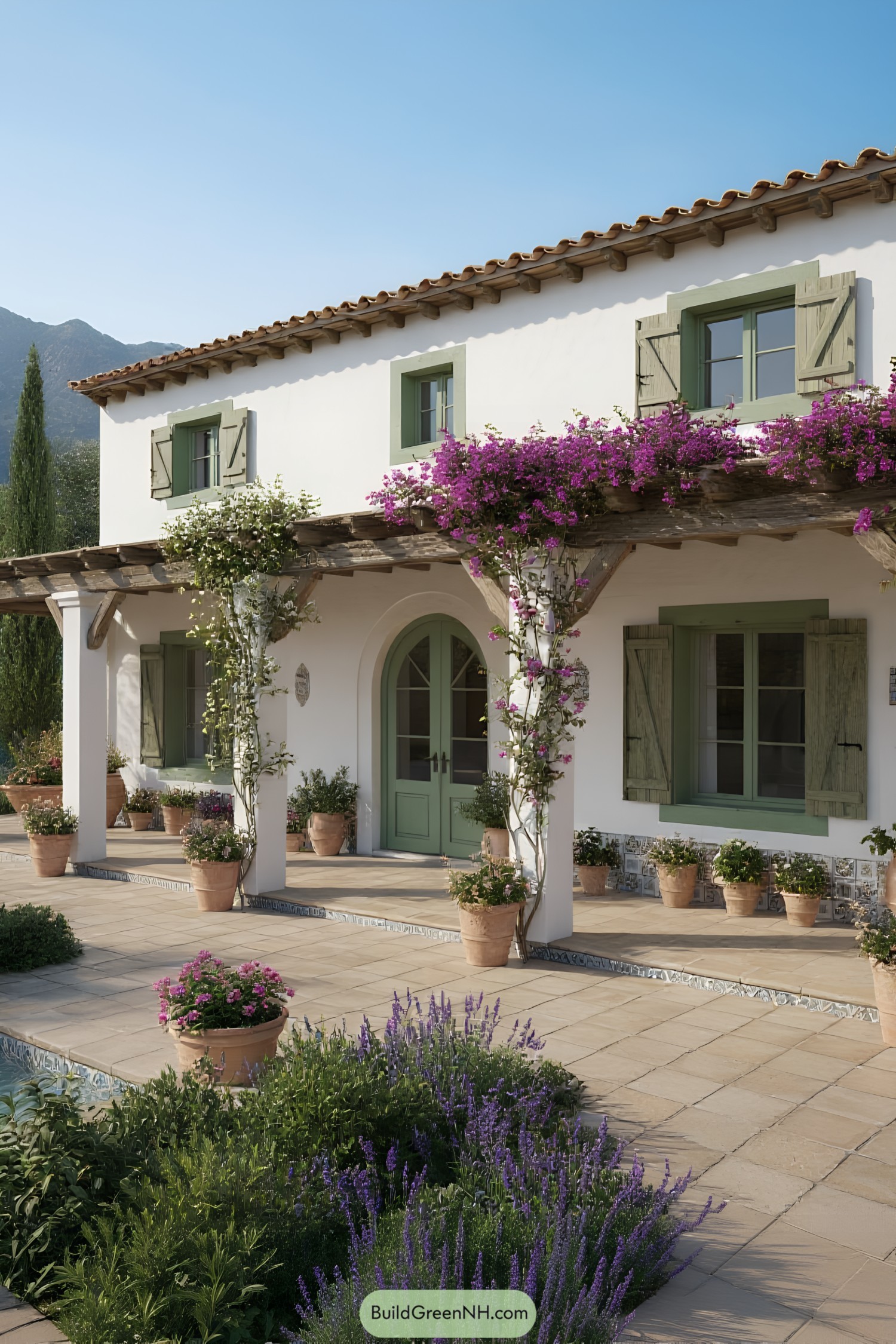 Mediterranean house with rustic green shutters and colorful flowers