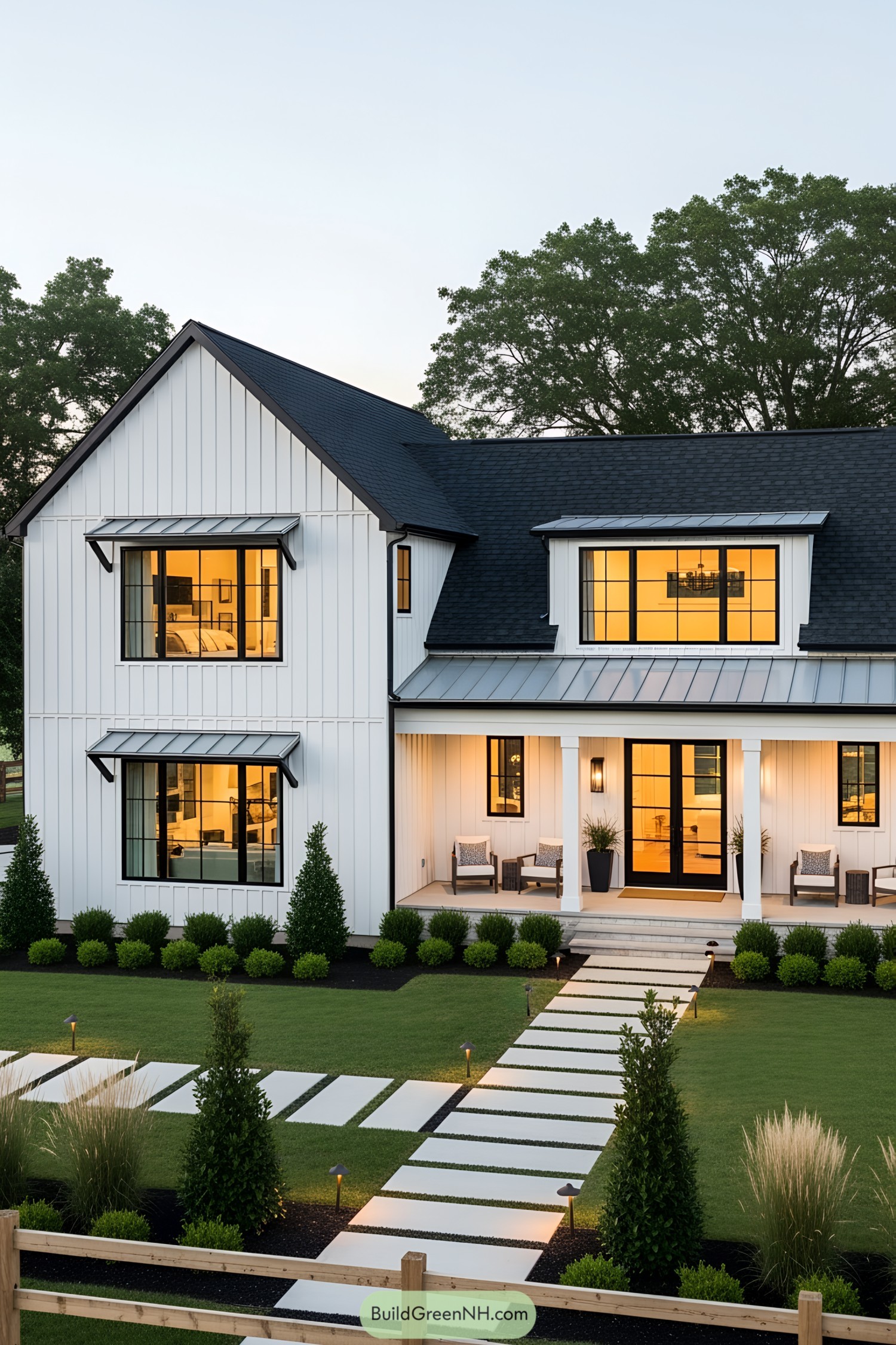Modern white country house with large windows and manicured lawn