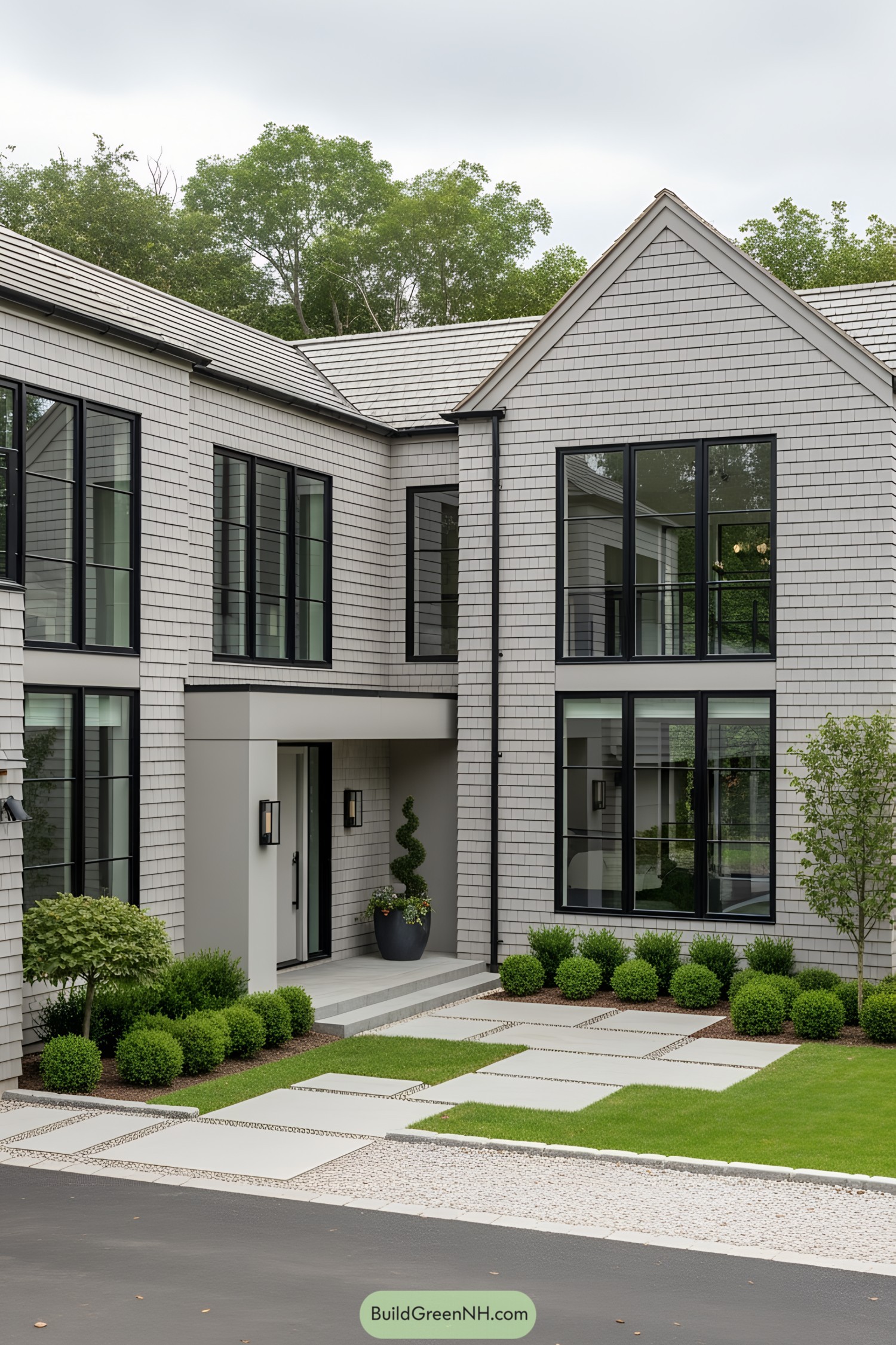 Modern house with black-framed windows and lush landscaping