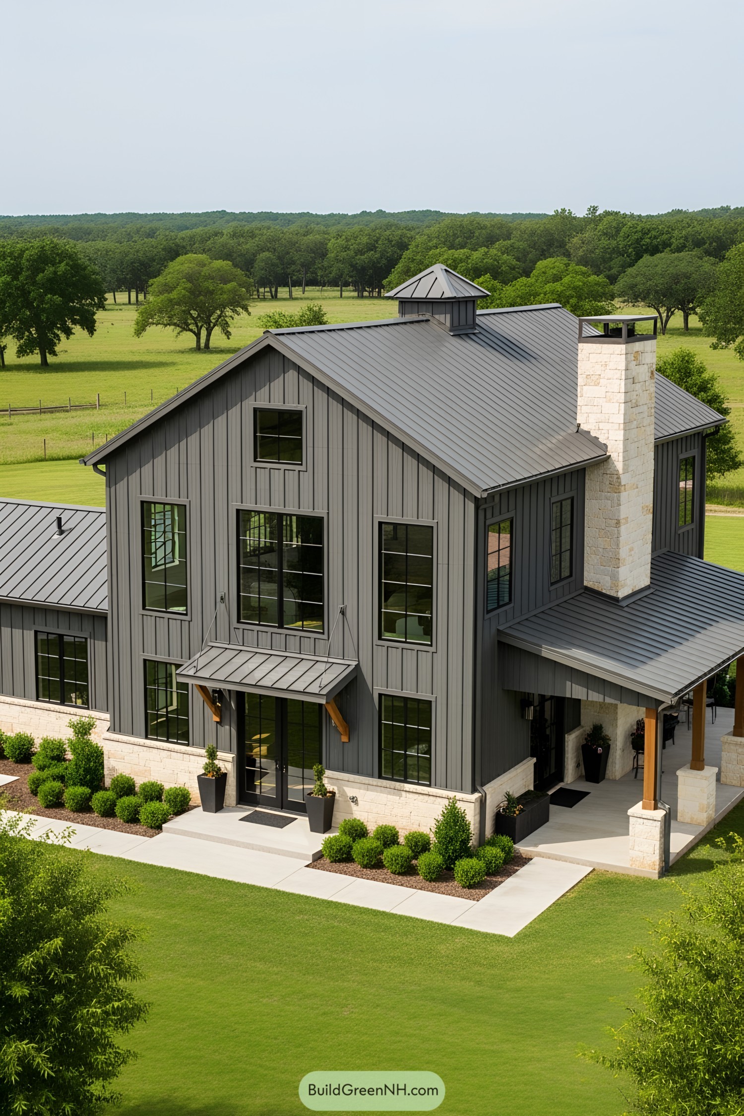 Sleek multi-level barndominium with expansive windows and lush surroundings