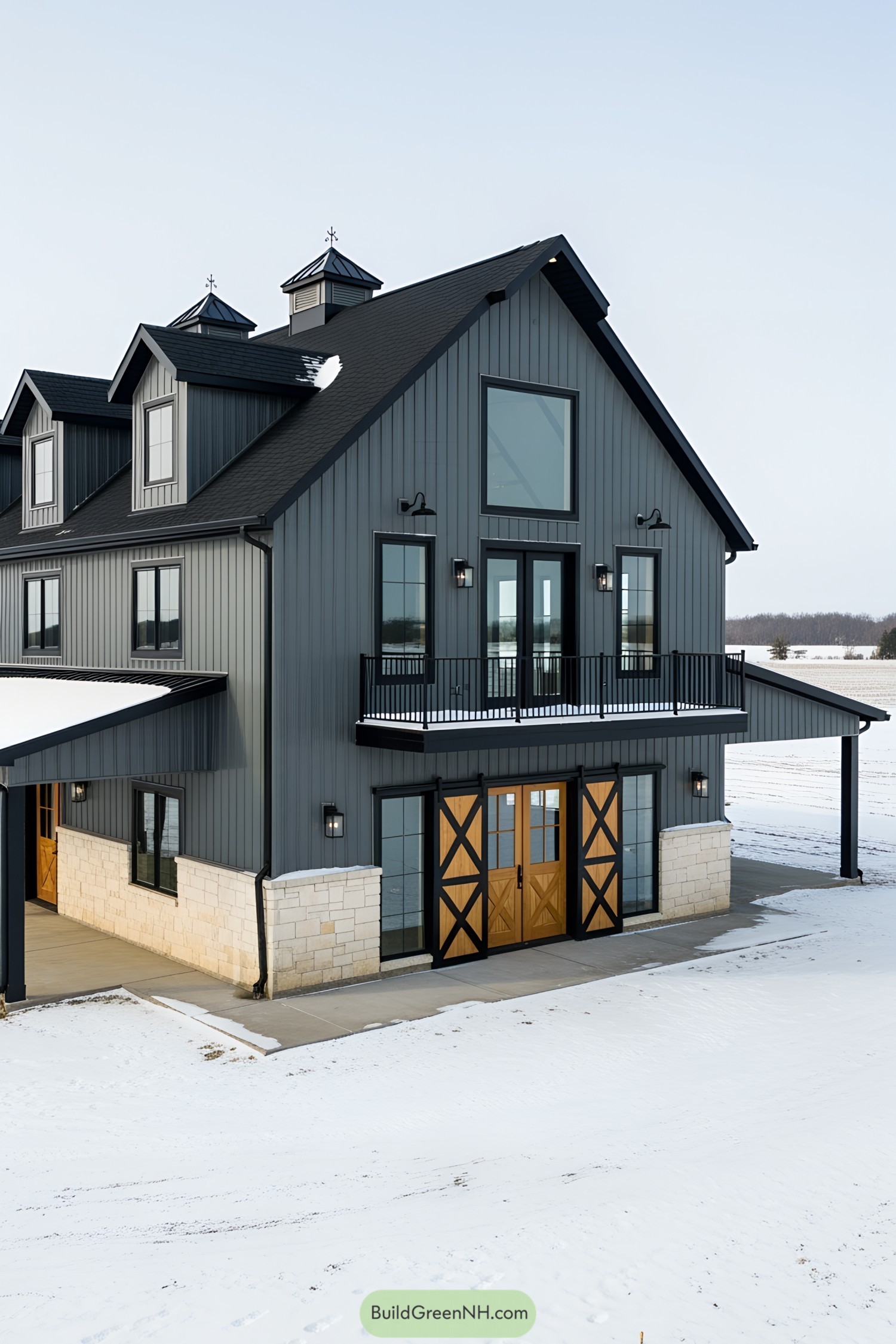 Elegant gray barndominium with snow-covered surroundings